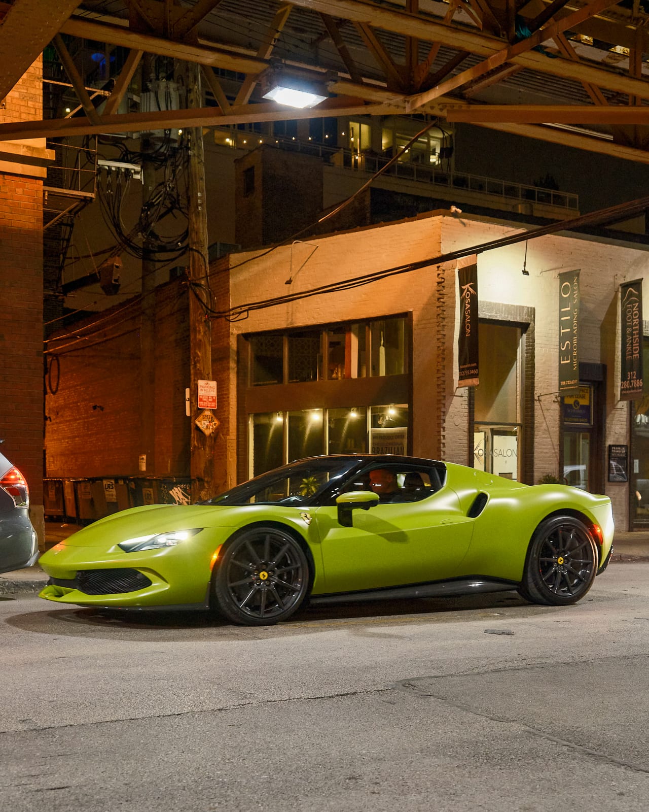Guests arriving past a Ferrari and several Rolls-Royce cars for Jason M. Peterson high-end photography event in Chicago.