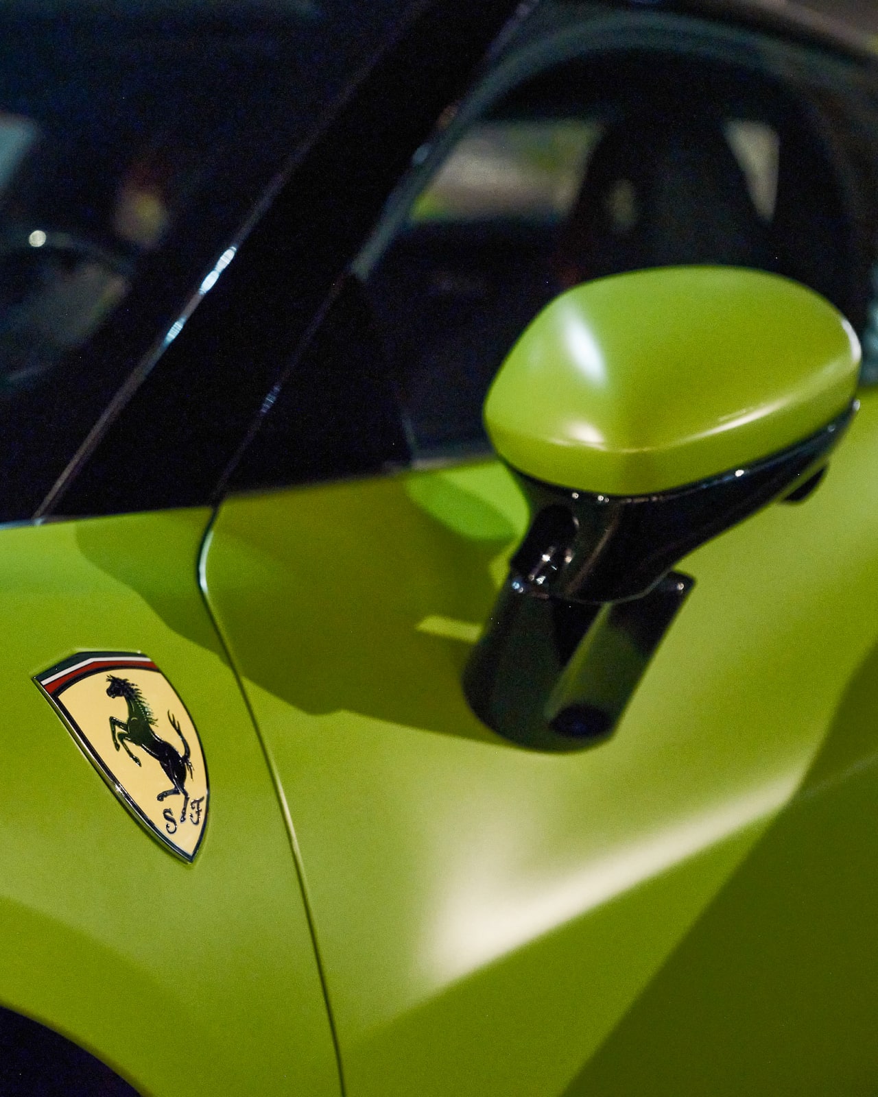 Close-up detailed photo of gorgeous vibrant Ferrari parked outside River North VIP event.