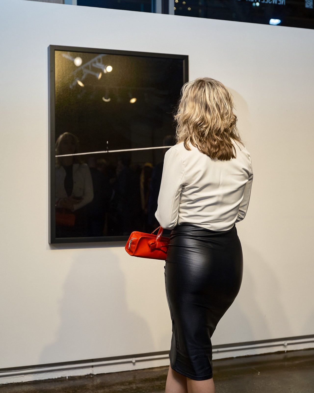 High-end clientele viewing Jason M. Peterson prints during River North gallery reception in Chicago.