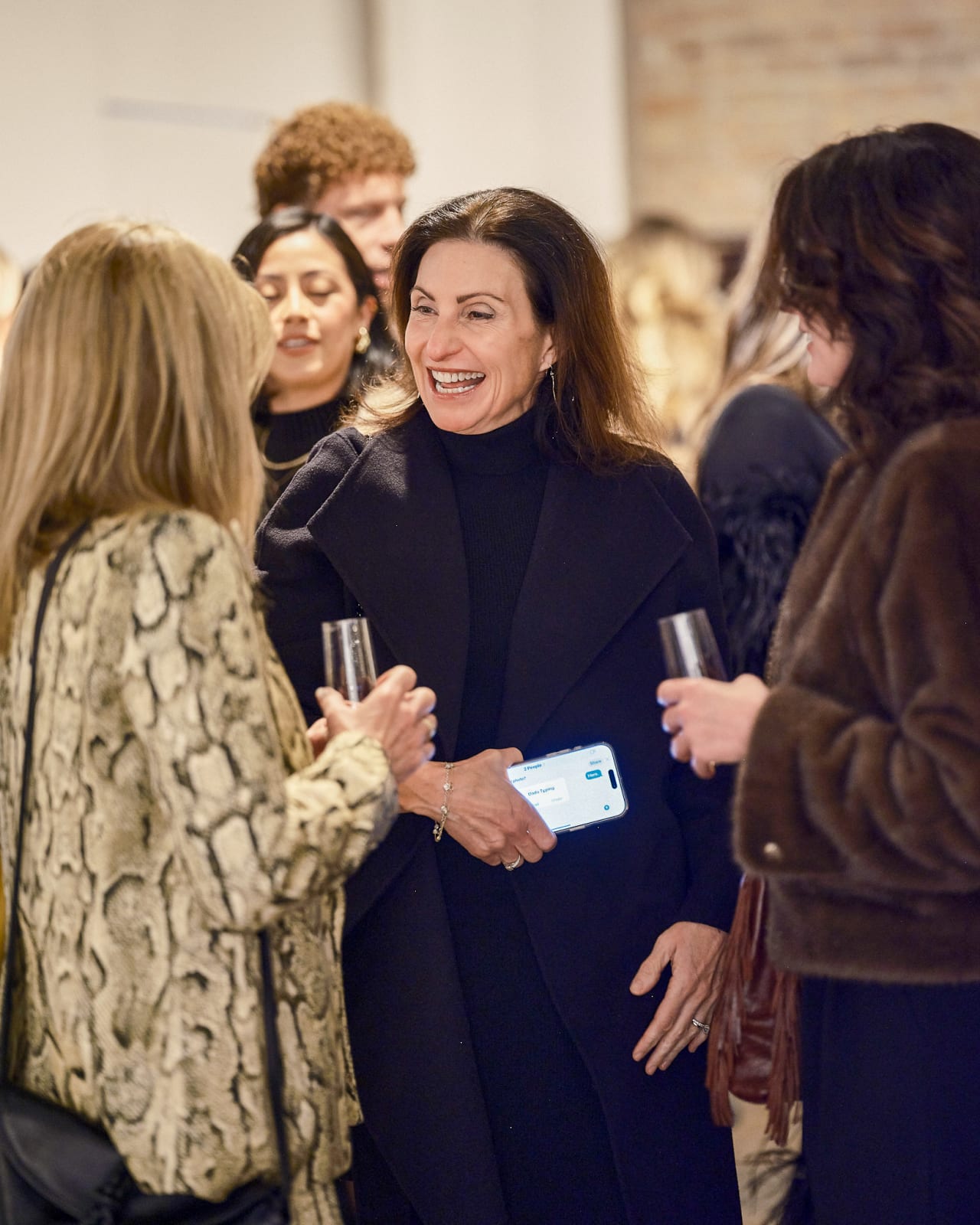 Group of brokers discussing market trends beneath Jason M. Peterson Chicago skyline photograph.