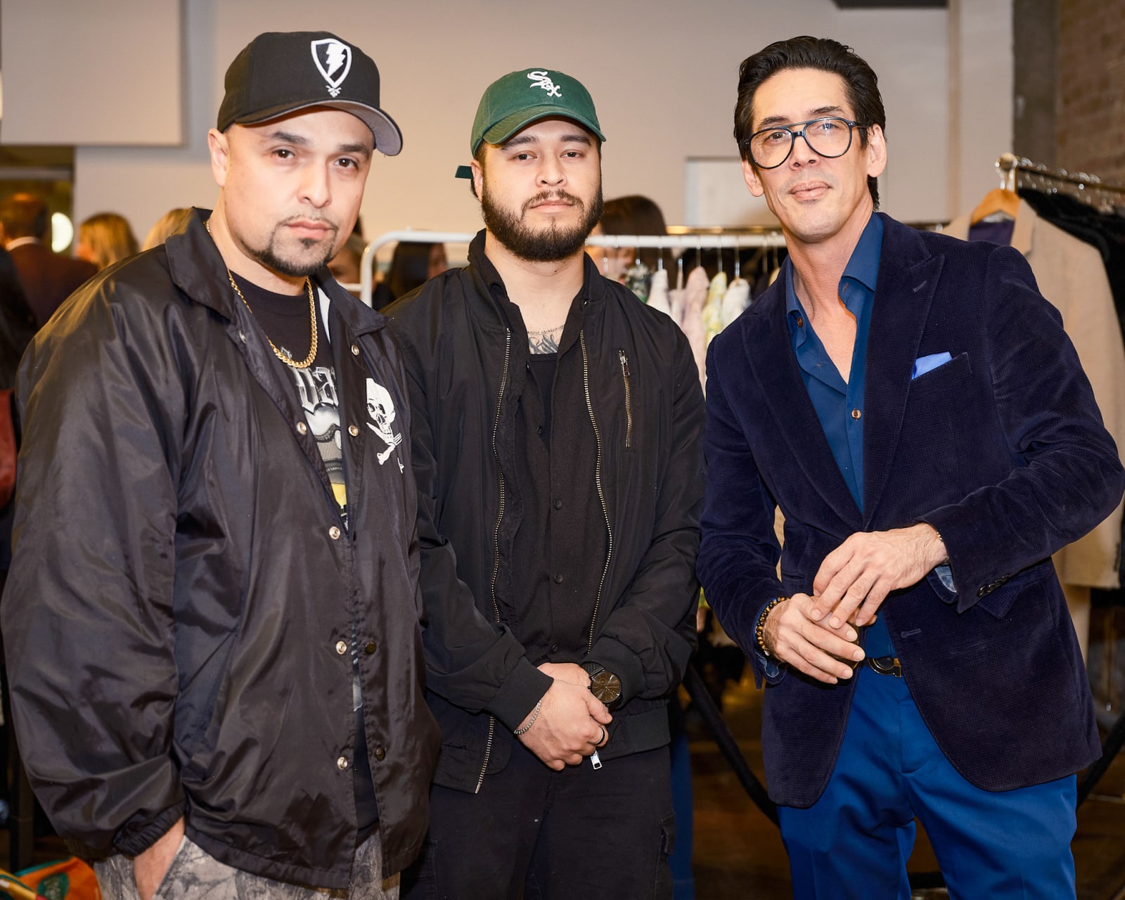 Guests posing together in front of Jason M. Peterson black and white photograph at our River North Chicago gallery event.