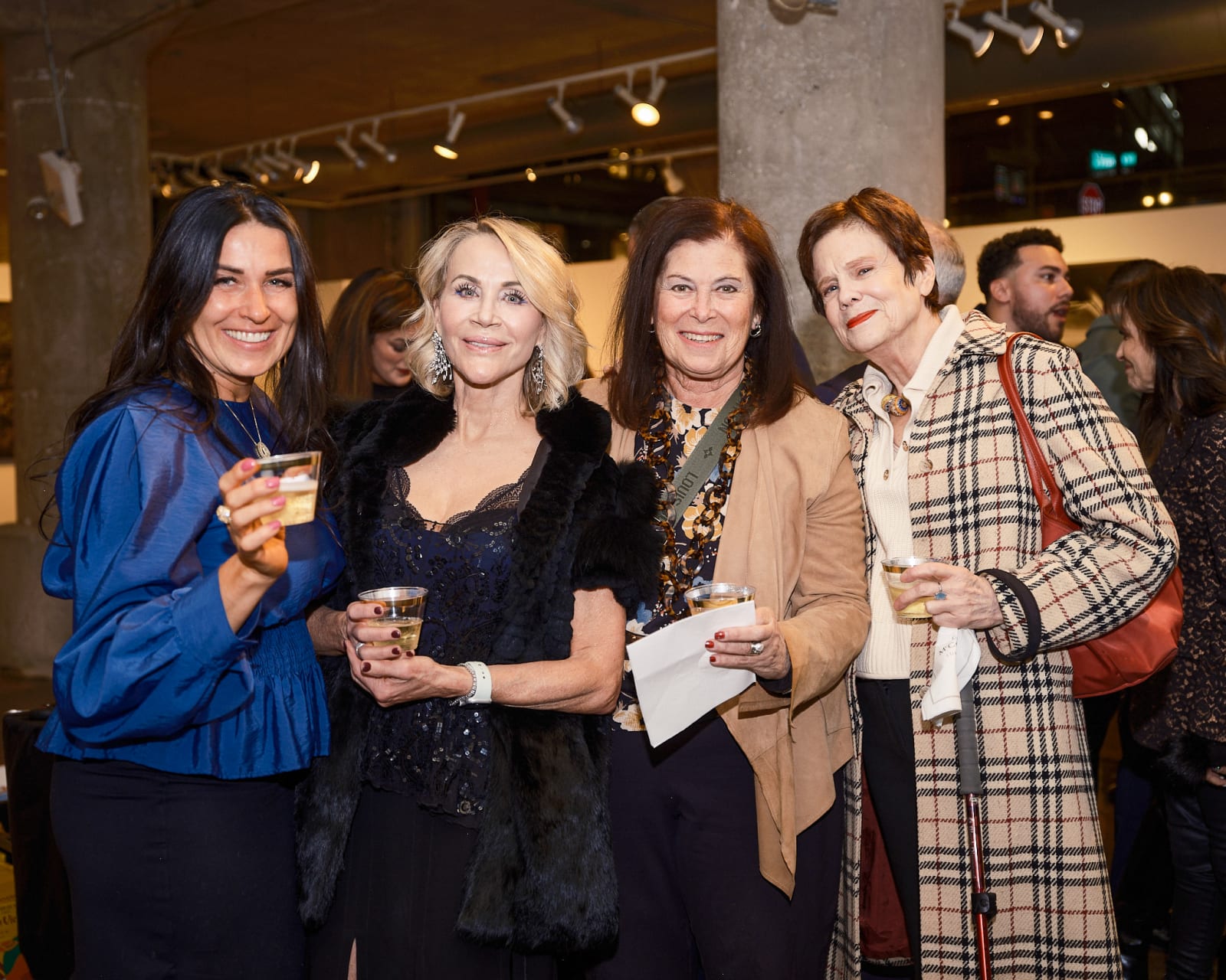 Friends posing for a candid snapshot with Jason M. Peterson street photography wall as the River North backdrop.
