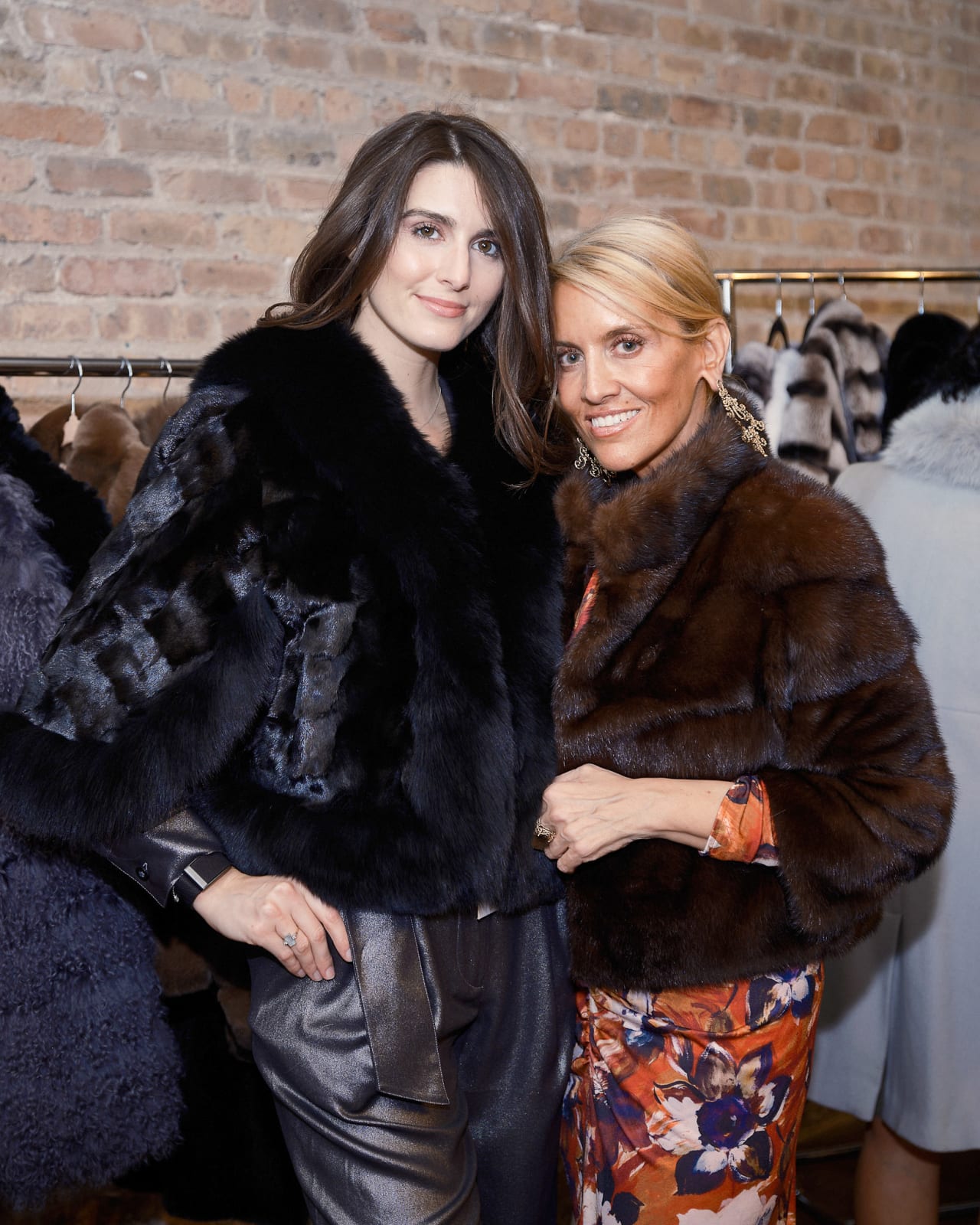 Gallery owner smiling with client for a photo beneath Jason M. Peterson cityscape print at luxury River North opening.