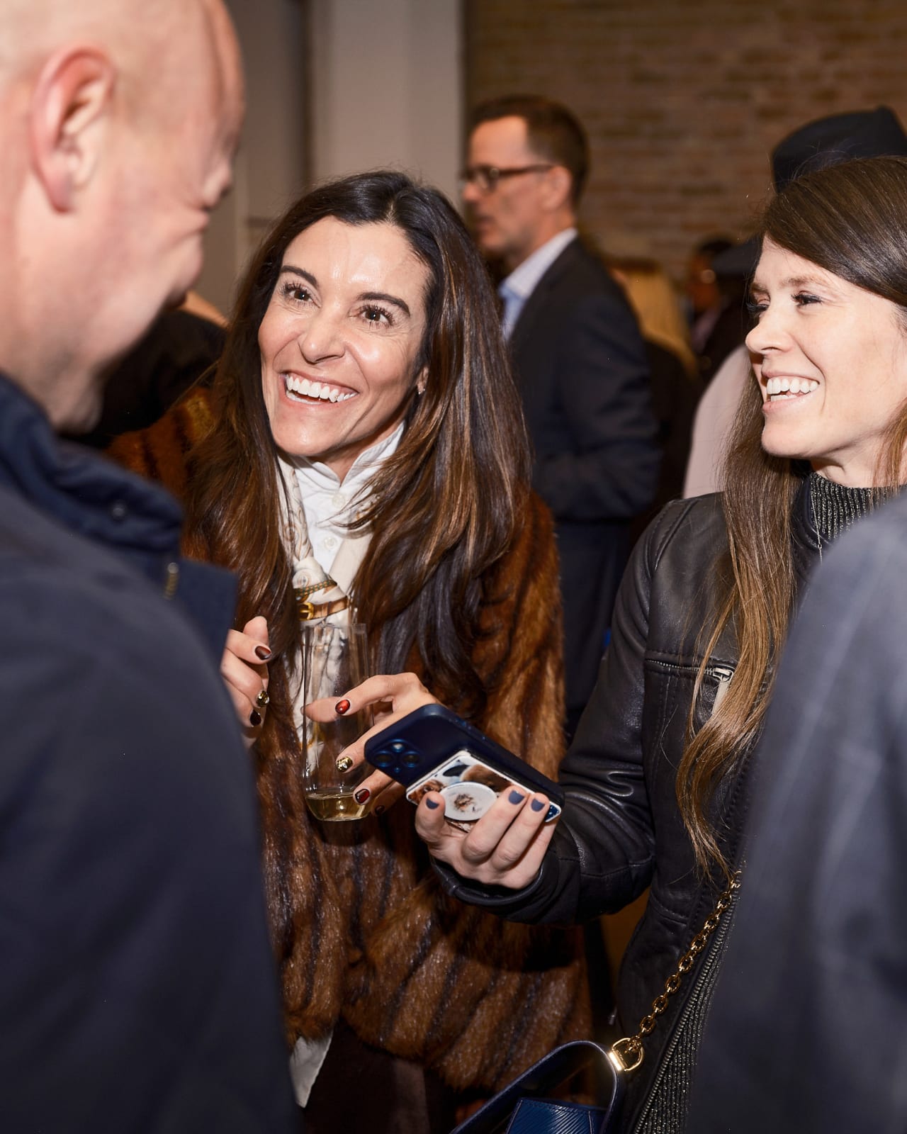 Client and advisor captured mid-conversation in front of Jason M. Peterson night skyline piece at River North gallery.