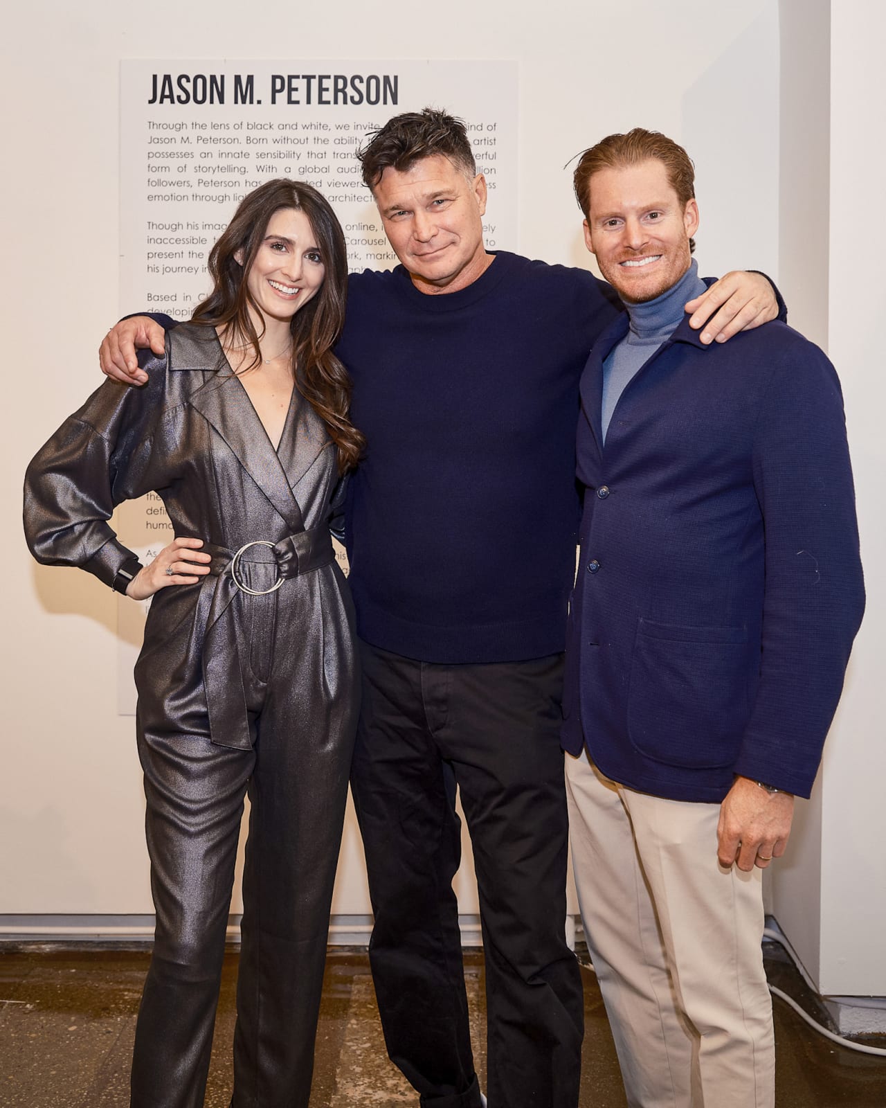 Artist Jason M. Peterson posing for a photo with gallery owners during VIP River North event.