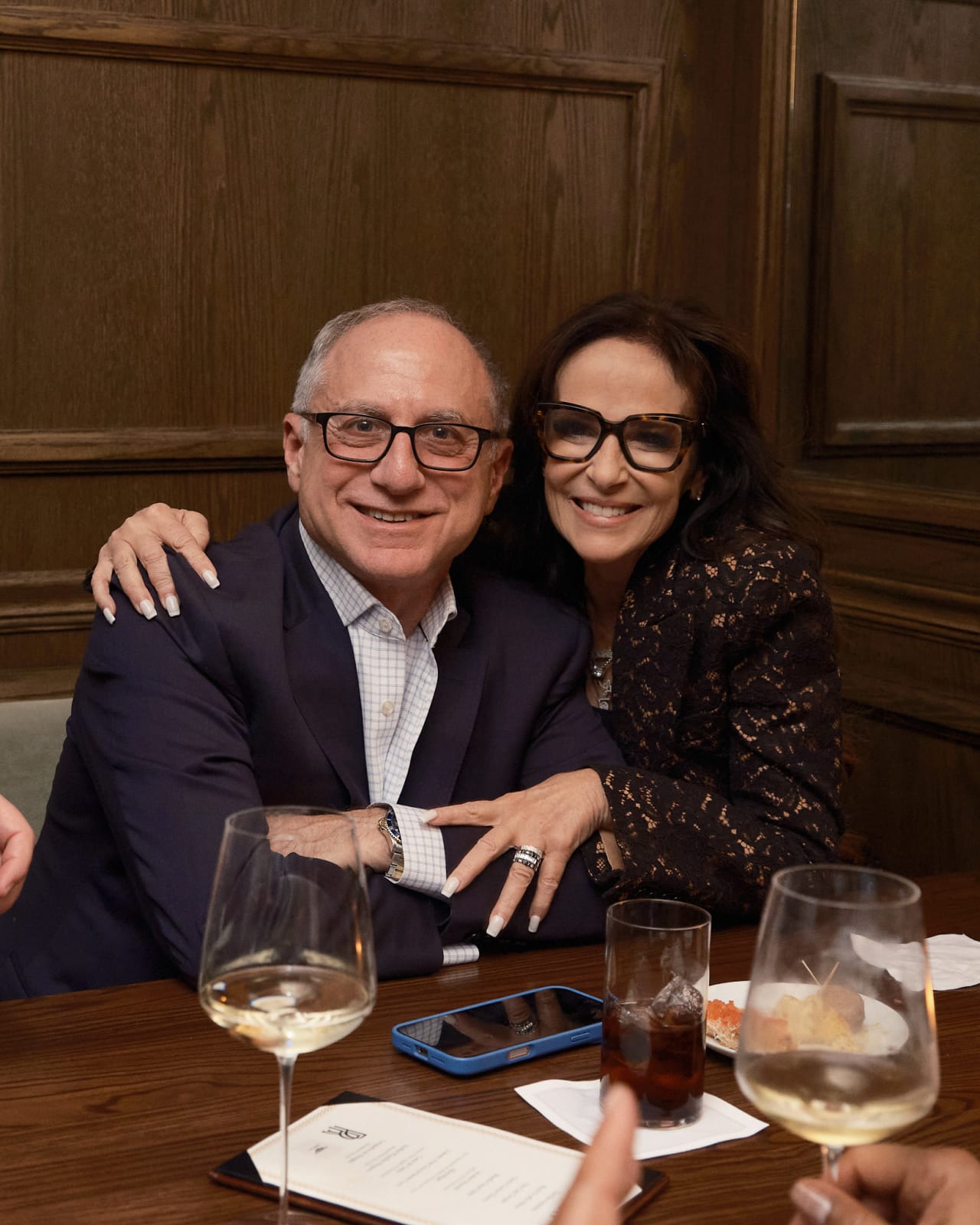Happy group of guests raising glasses toward camera while at the closing reception.