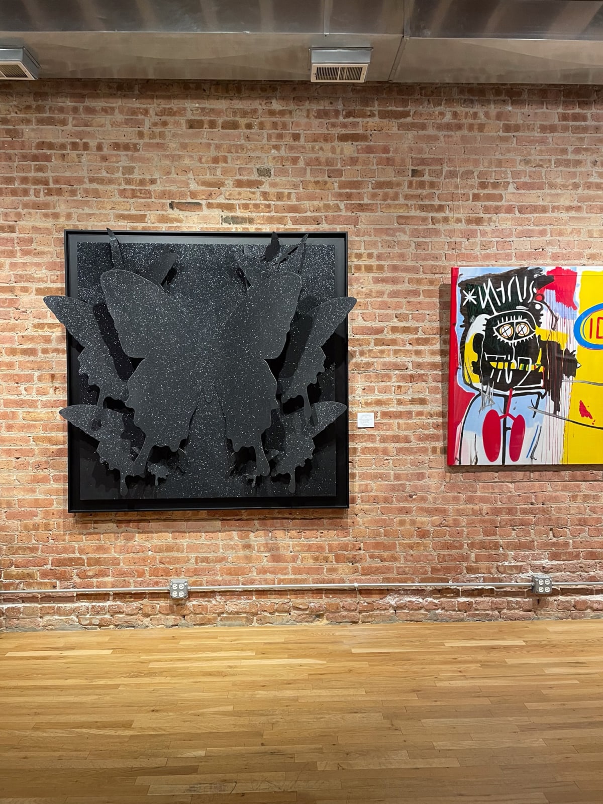 Paintings displayed on wall at Carousel Fine Art's gallery space in Chicago.