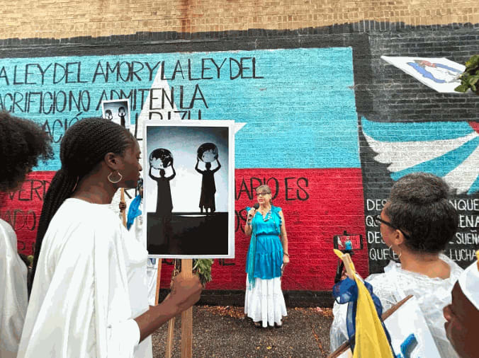 Local poet and documentarian Marina Ortiz in front of the “Dos Alas” mural.