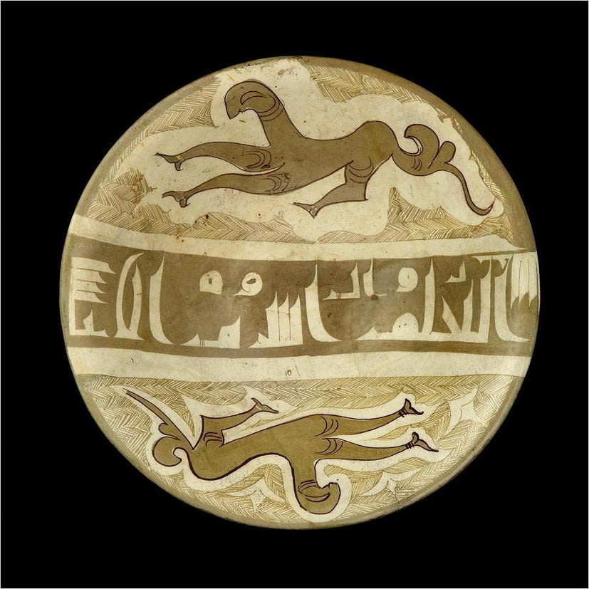A RARE BOWL WITH GROTESQUE FIGURES AND KUFIC CALLIGRAPHY