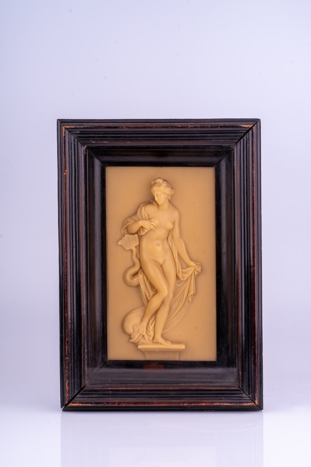 A George III sculpted wax relief of Venus with a dolphin, early 19th century