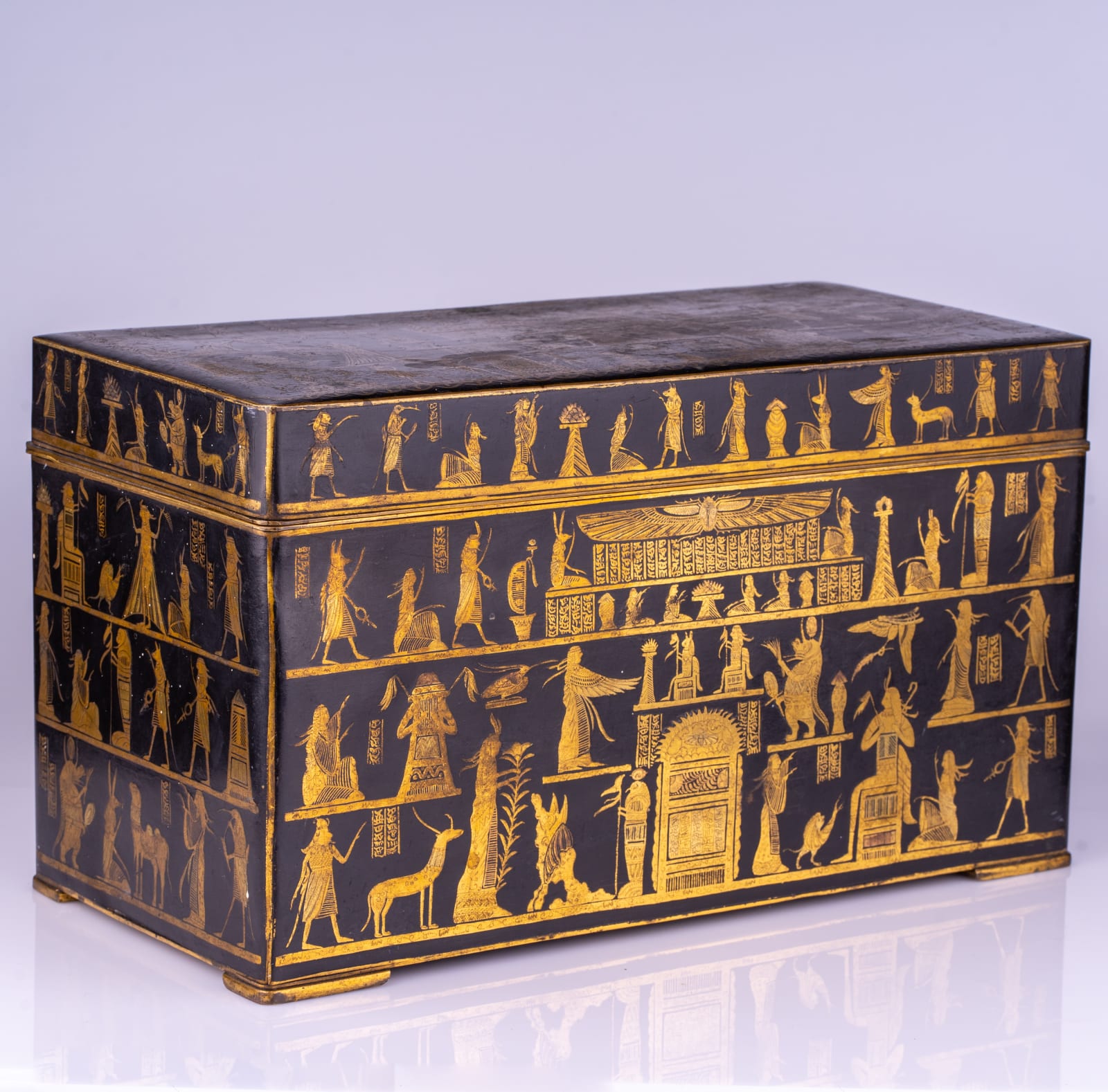 An Egyptian revival gilt brass and lacquered casket, late 19th/early 20th century