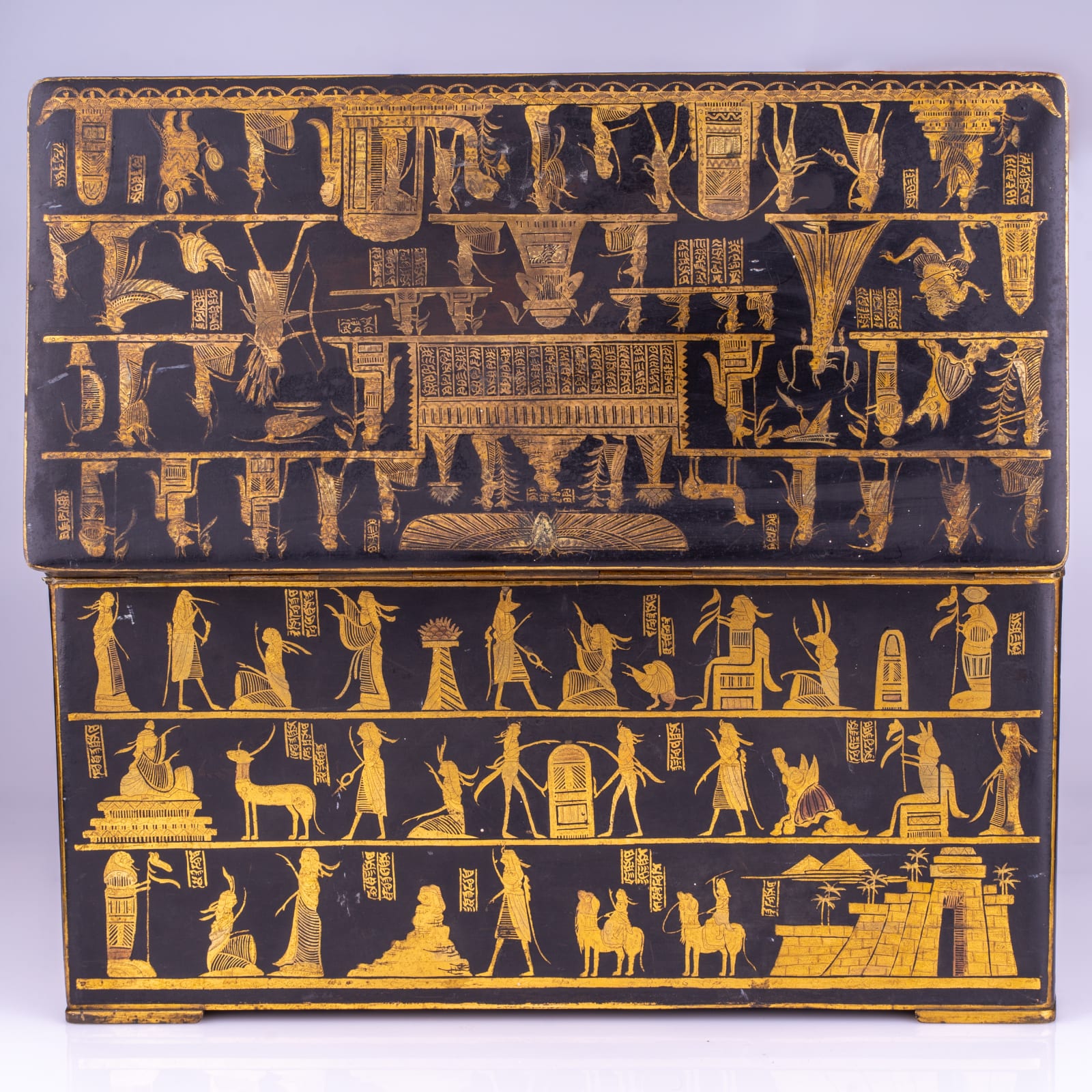 An Egyptian revival gilt brass and lacquered casket, late 19th/early 20th century