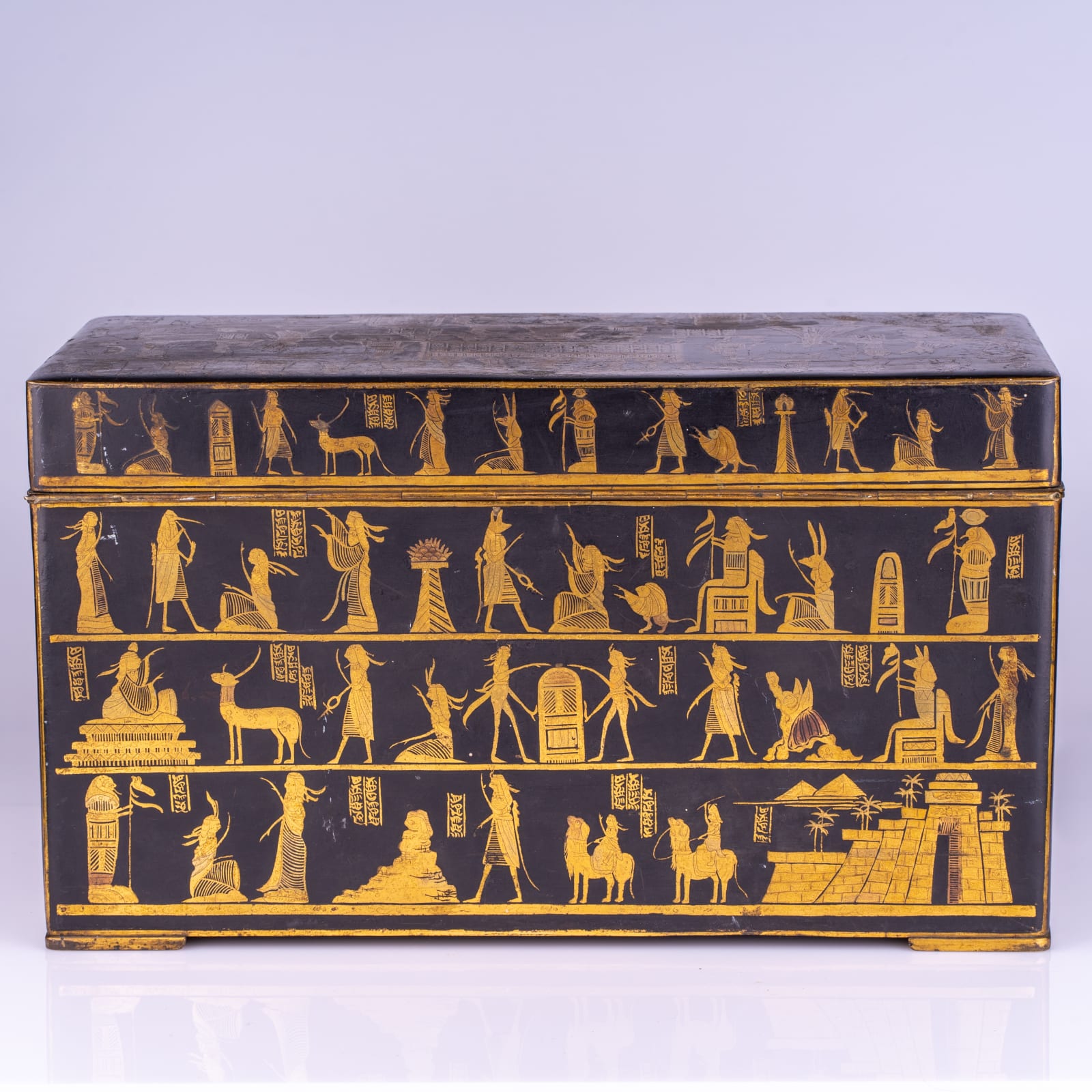 An Egyptian revival gilt brass and lacquered casket, late 19th/early 20th century