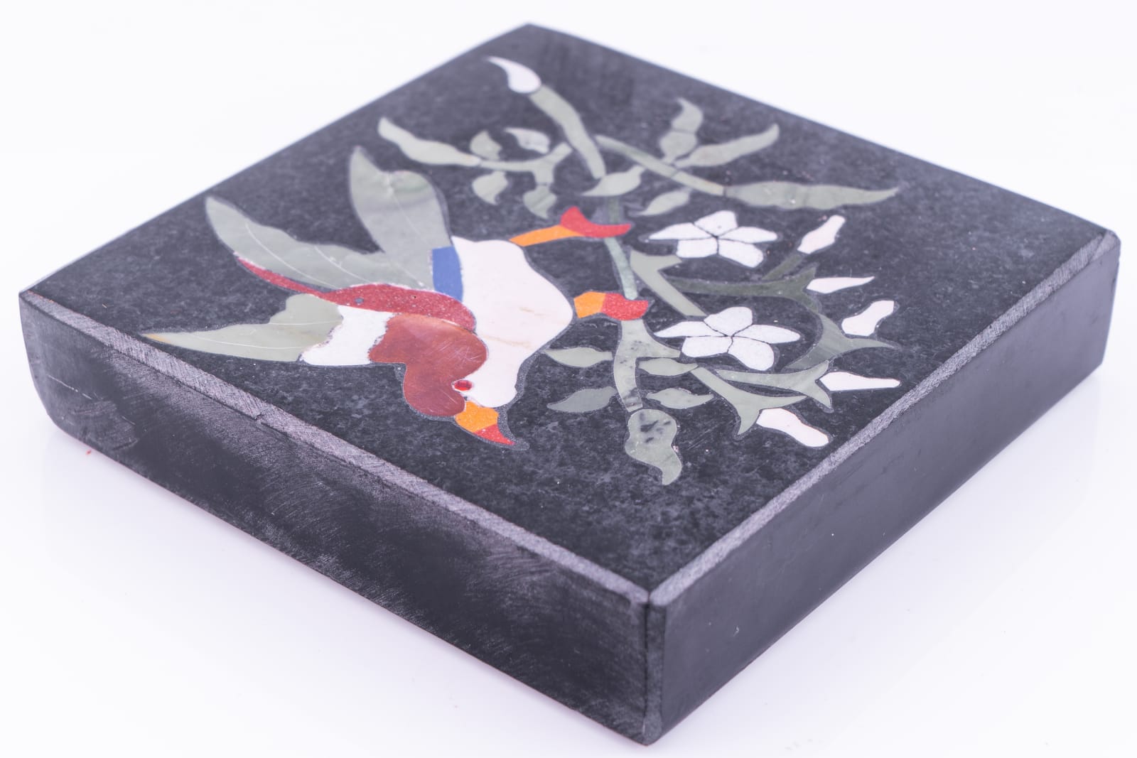A paperweight with a bird on branch