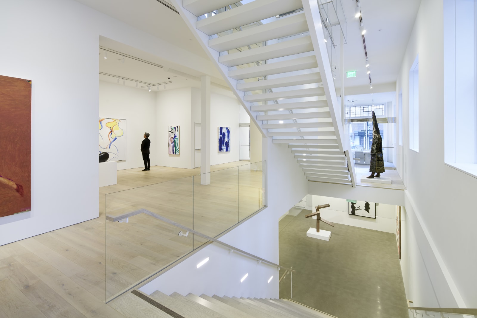 Ground floor facing north, featuring the center staircases to the second floor and lower level of the gallery. Installation view of The Human Form, January 13-March 11, 2017.