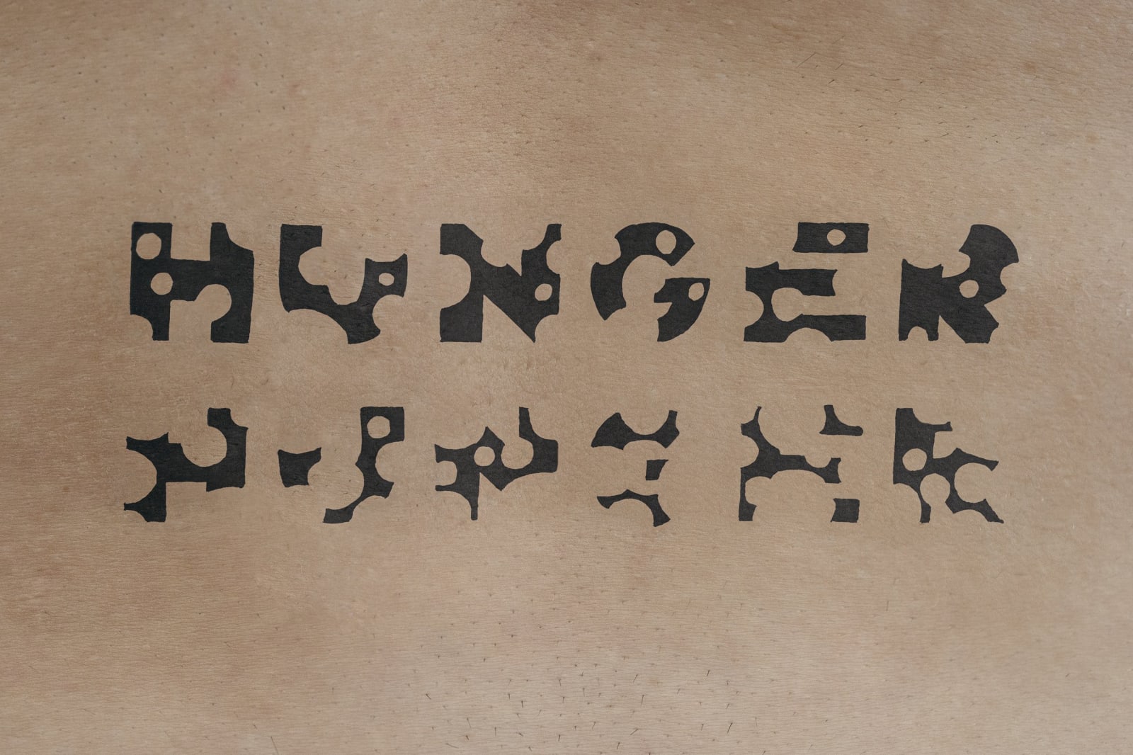Roee Rosen, Hunger, Hunger, 2024, 40 X 60 cm, from the series The Gaza War Tattoos, © Roee Rosen