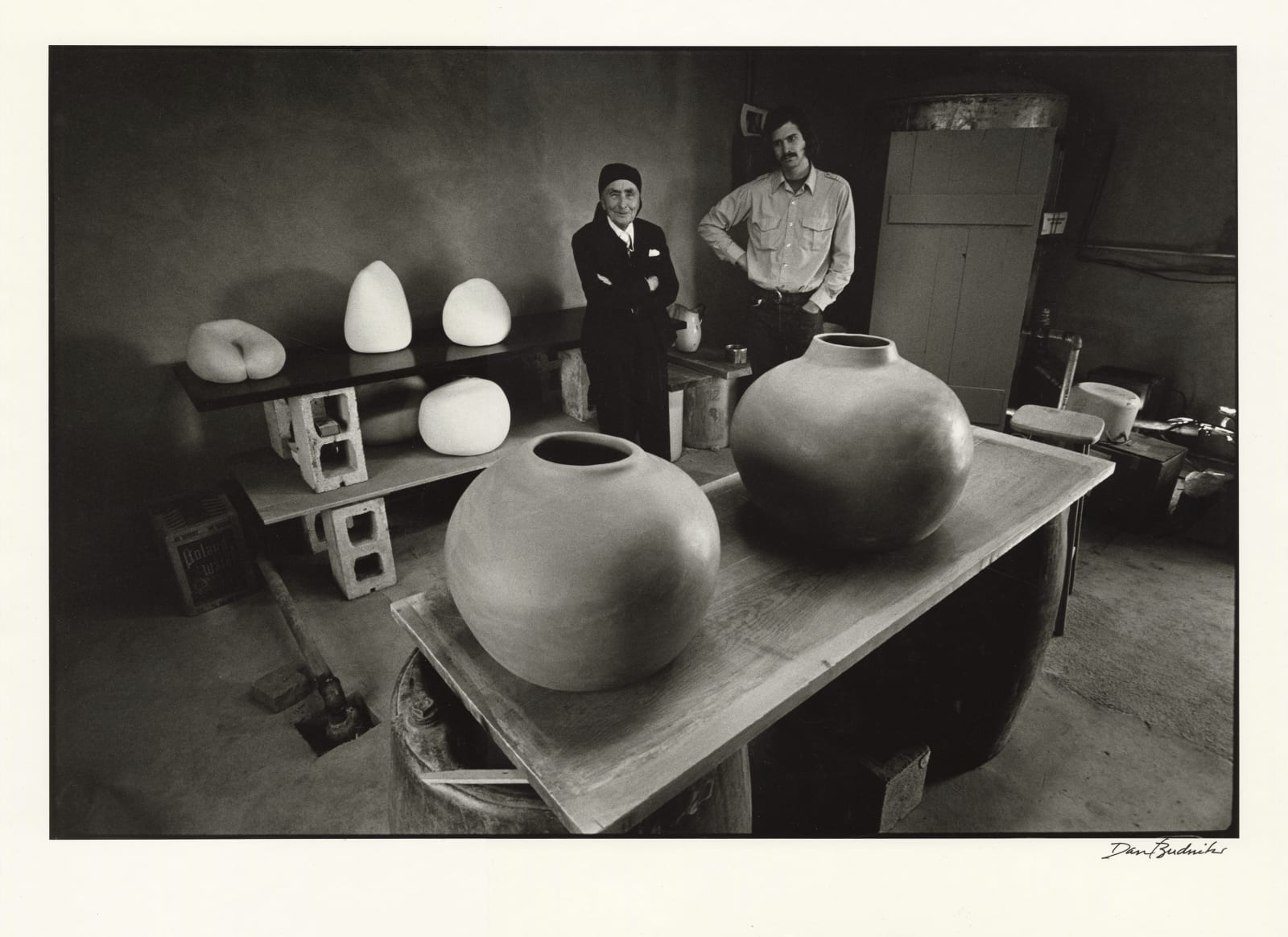 Dan Budnik, The Ghost Ranch potting shed, Georgia O'Keeffe and Juan Hamilton, with his ceramic pots, New Mexico, March 1975, 1975