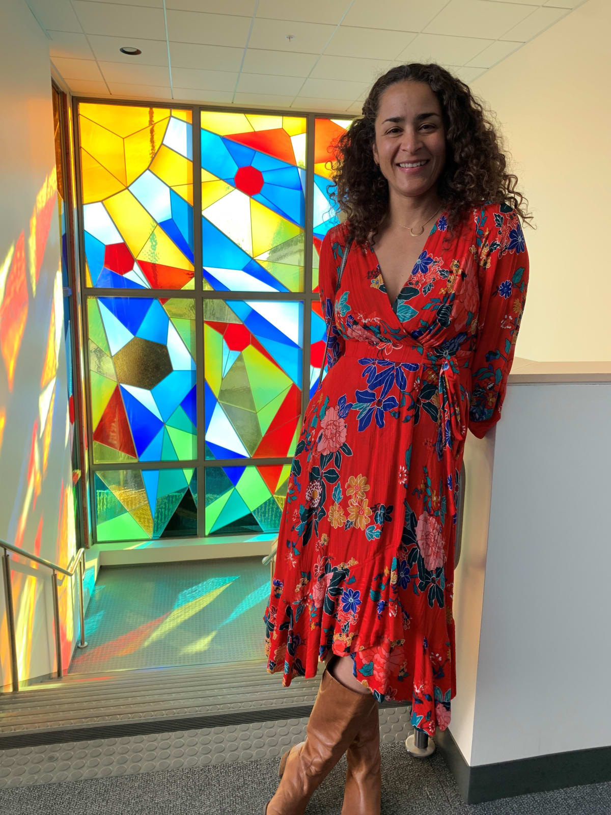 Artist Adia Millett in front of the artwork