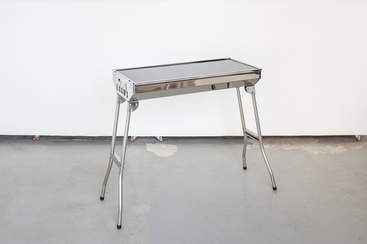 Kobby Adi FULL BLOOM (deep + held), 2019 Stainless steel bbq, tinted glass, soil, hope, Morley’s chicken bones, amber rosin, magnum condom, cold and flu remedy 71 x 33 x 70 cm