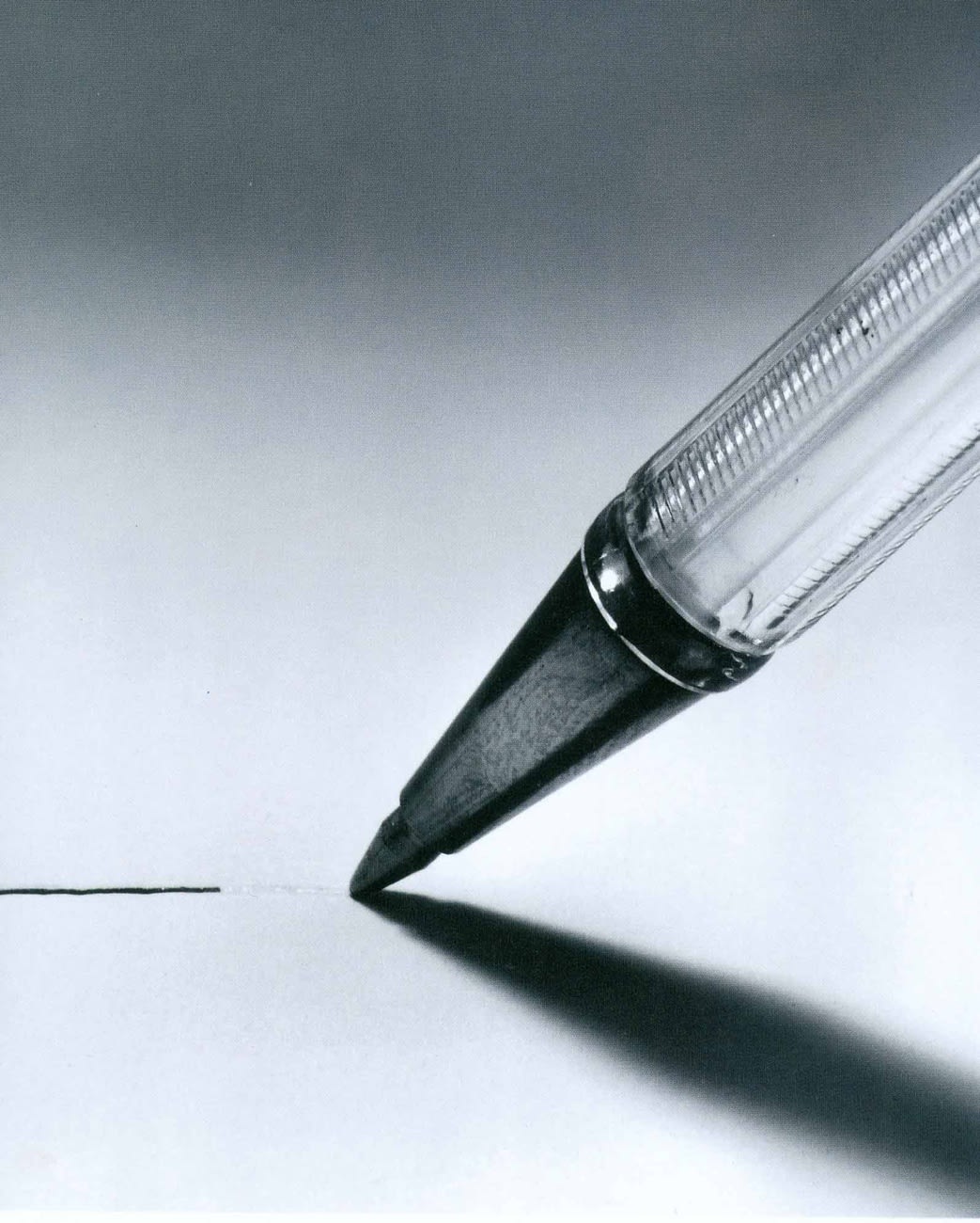 A ballpoint pen drags across a piece of white paper. The ink line stops abruptly as if it has run out. 