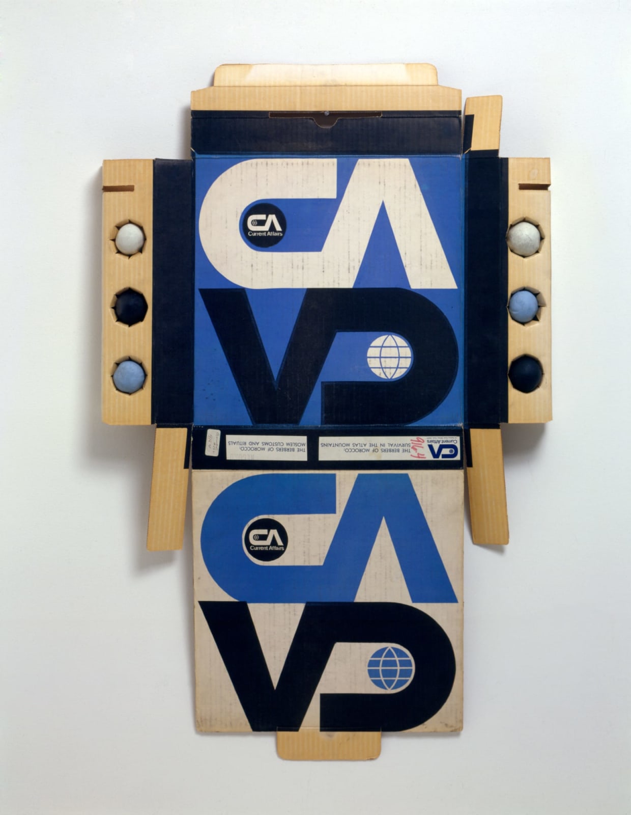 Cardboard packaging with a repeated logo printed in white, black and blue with the letters C A V D. 