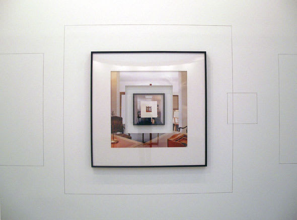 A framed photo of a photo within a photo within a photo depicting parts of a brightly-lit room.