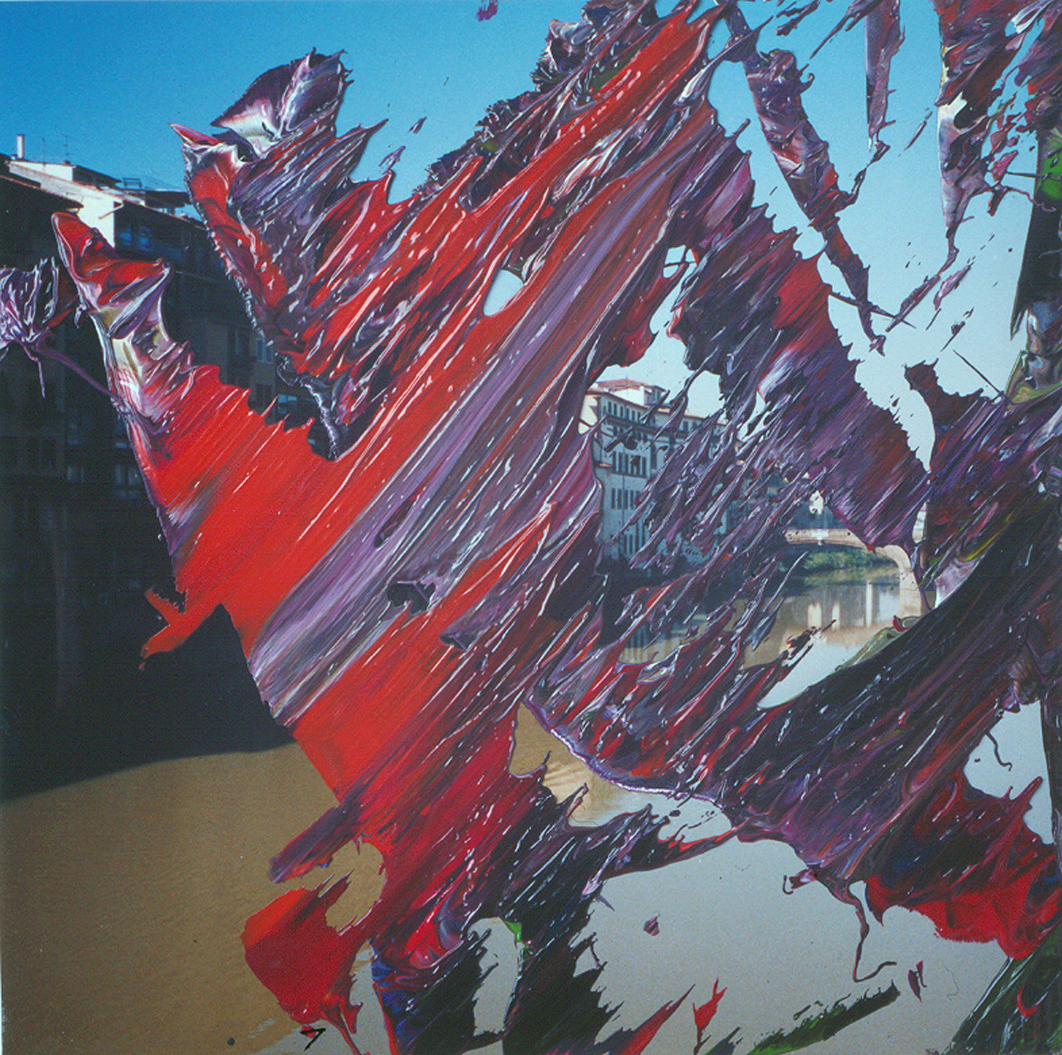 A photograph of a city painted over with broad strokes of red and purple.