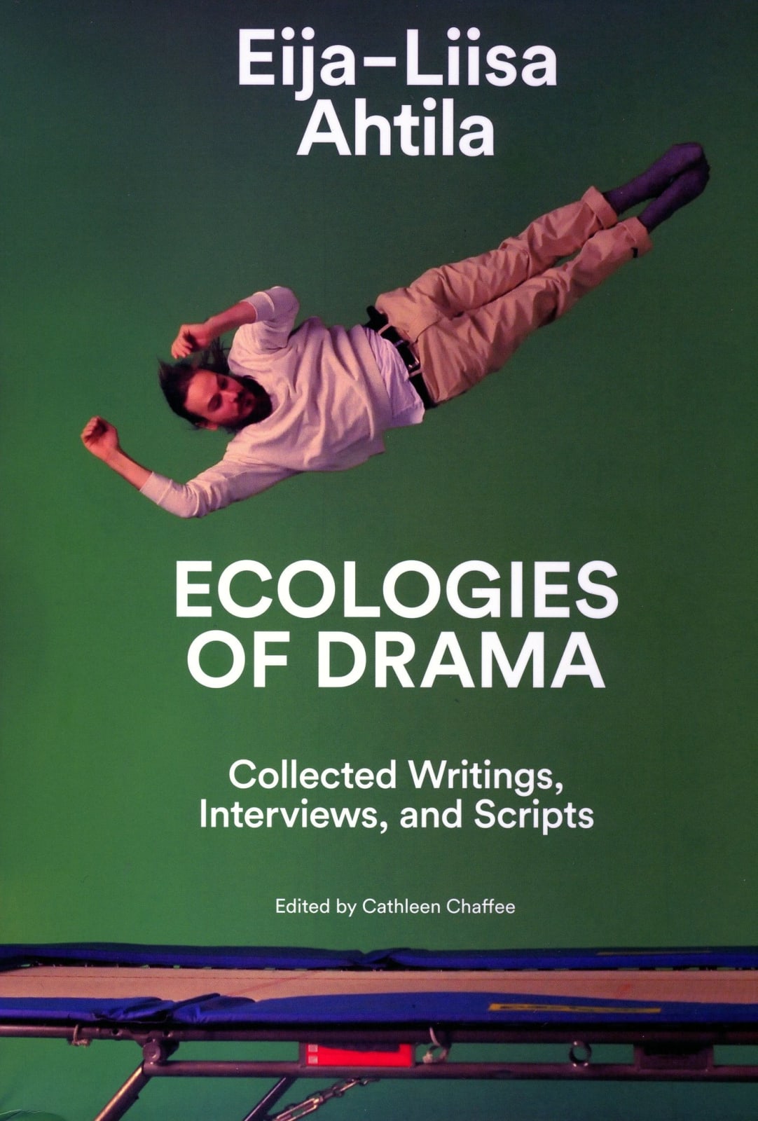 Book cover for Eija-Liisa Ahtila with a green solid background and a person dressed in pink falling.