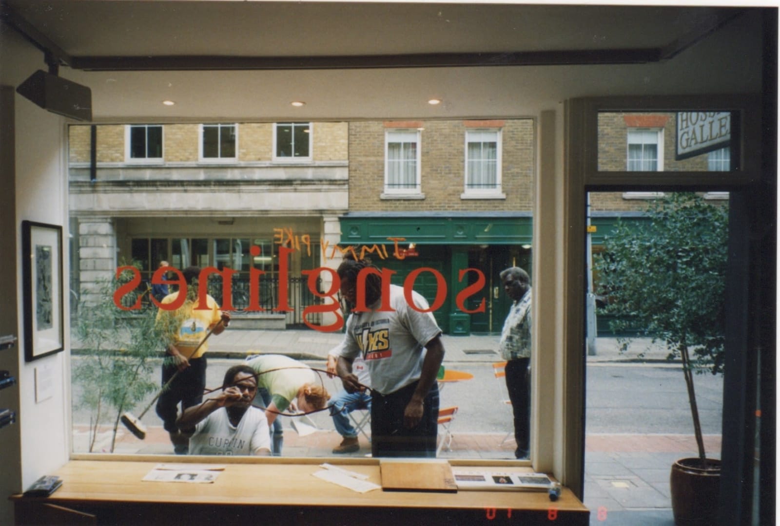 David Bosun, Billy Missi and Dennis Nona painting on the window at the Rebecca Hossack Art Gallery, London during their exhibition in 2001