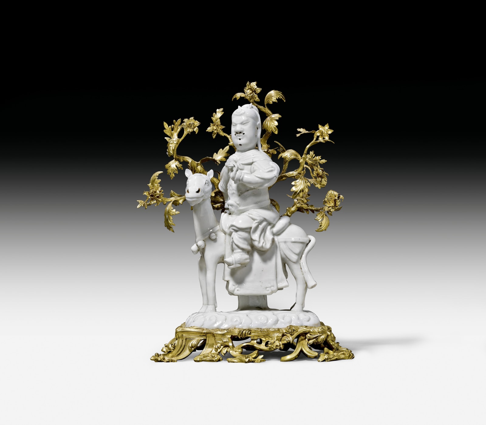 Unknown, A Kangxi figure of Guan-Di seated on his horse, The figurine: Dehua, China, Kangxi period (1662-1722); the gilt bronze mounts: Paris, circa 1740