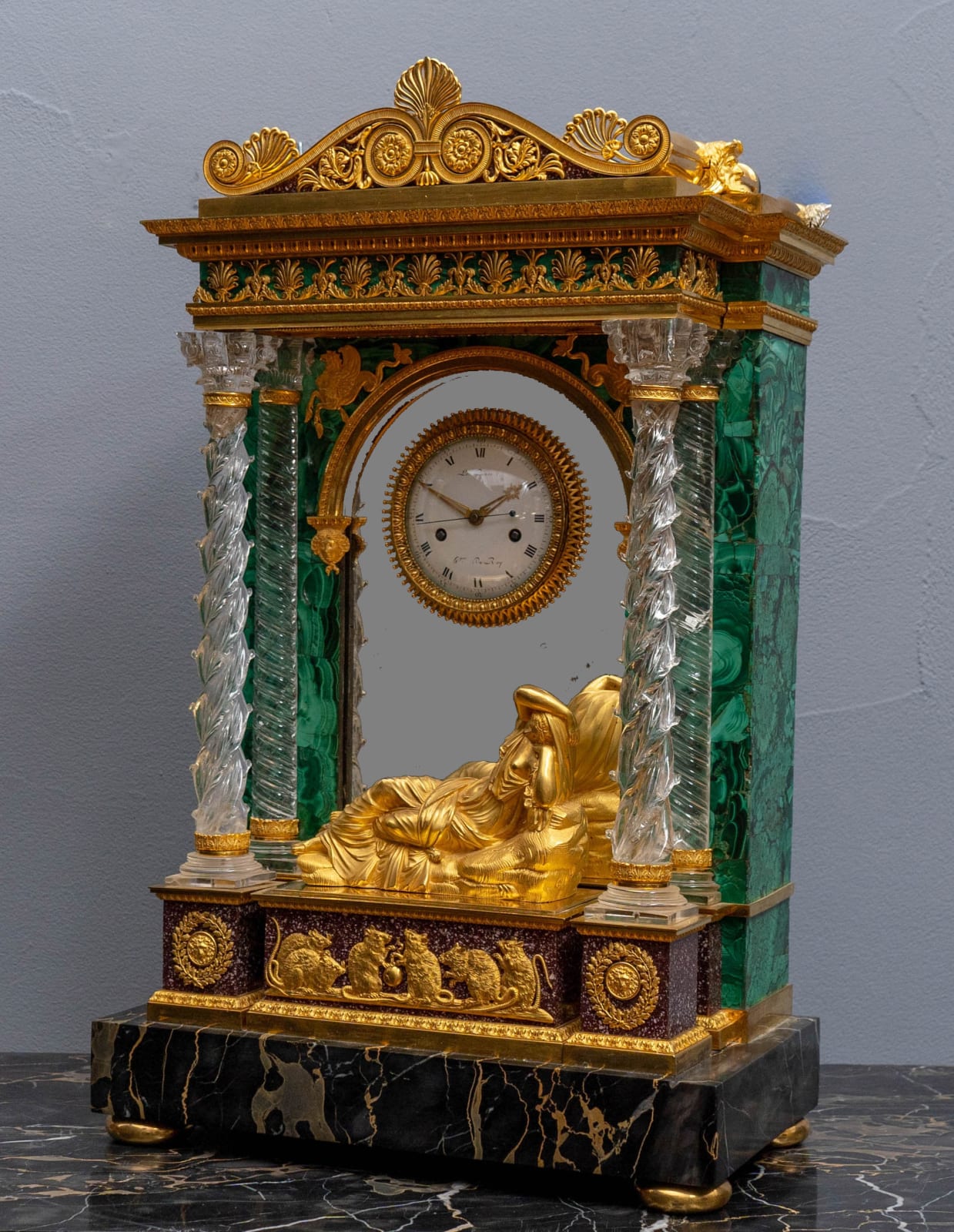 Lepaute, LEPAUTE THE BRONZE MOUNTS ATTRIBUTED TO FRANÇOIS RÉMOND EXCEPTIONAL AND UNIQUE PORTOR MARBLE, EGYPTIAN PORPHYRY, ROCK CRYSTAL, MALACHITE VENEER AND MATTE AND BURNISHED GILT BRONZE MANTEL CLOCK, Paris, date circa 1790