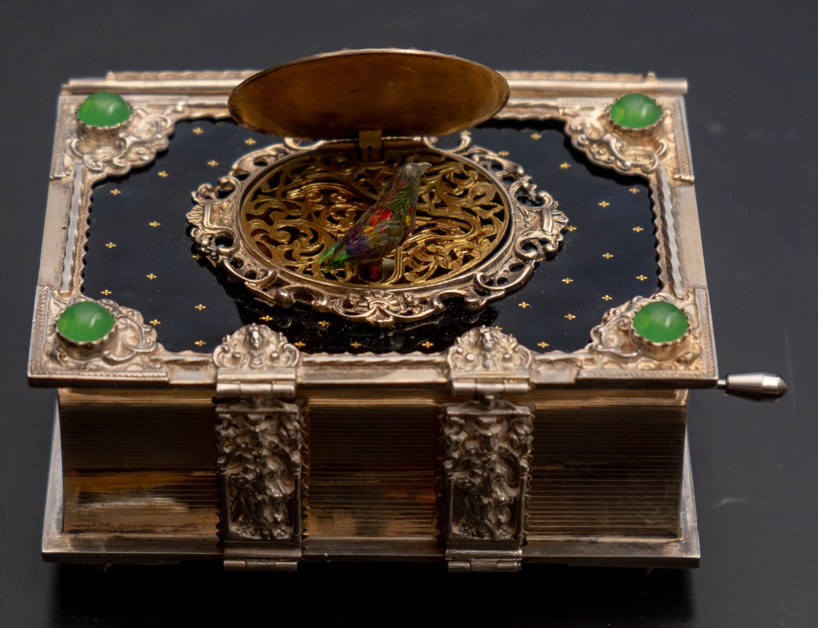 attributed to Karl Griesbaum, A GERMAN EARLY TWENTIETH CENTURY ENAMELLED SILVER SINGING BIRD BOX IN THE FORM OF A BOOK, The Black Forest, Germany, date circa 1925-35