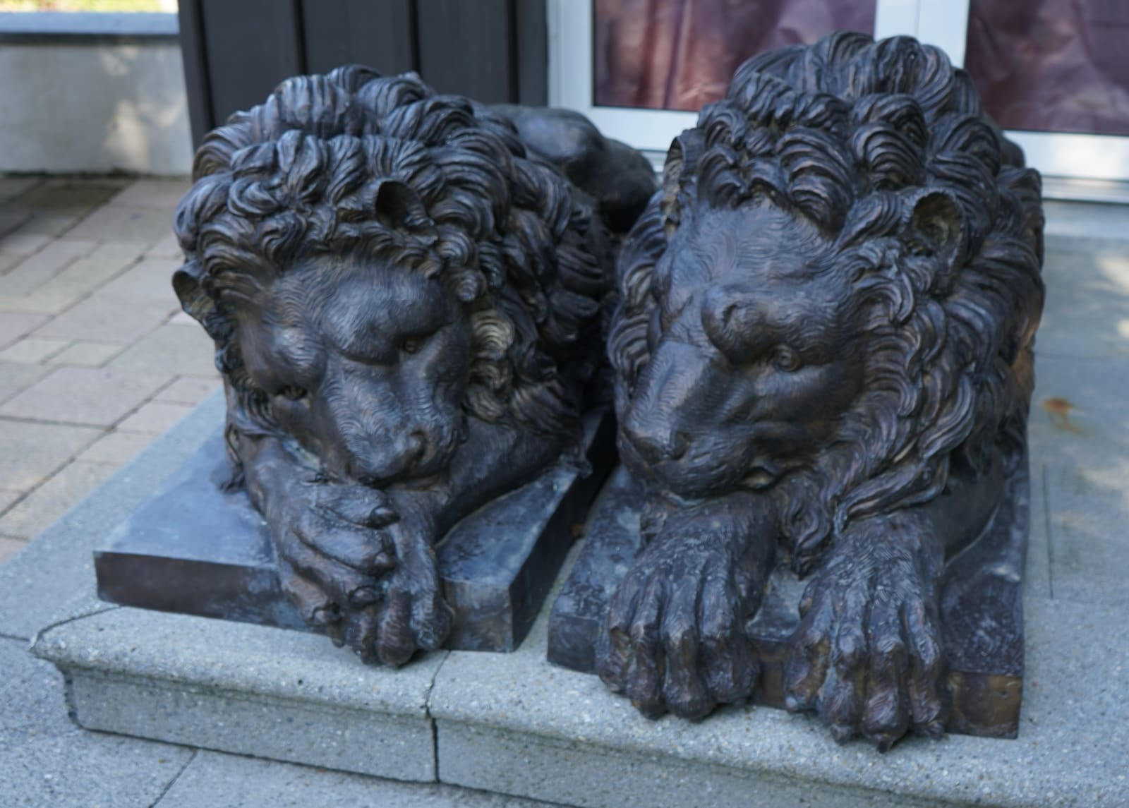 Antonio Canova, PAIR OF TWENTIETH CENTURY EUROPEAN PATINATED BRONZE RECUMBENT LIONS, Europe, either Paris or Rome, date circa 1900-70