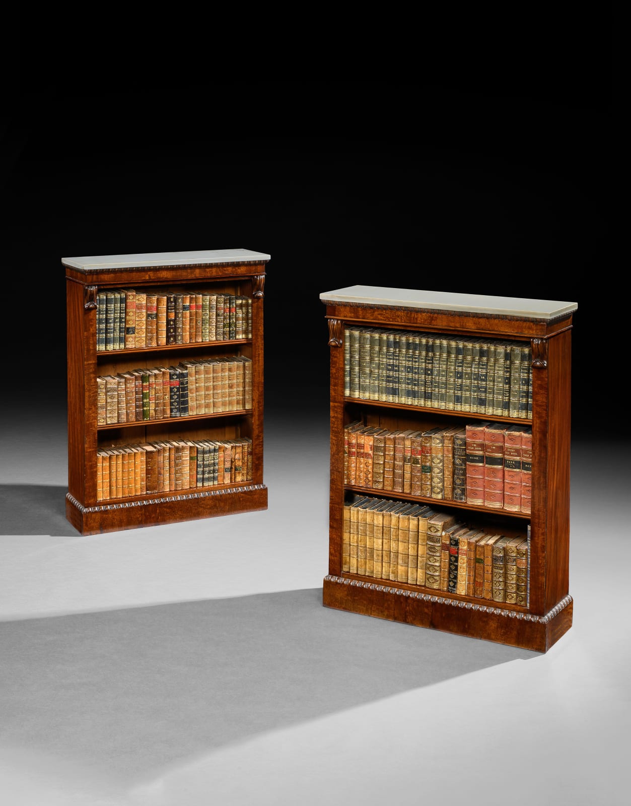 A PAIR OF REGENCY MAHOGANY OPEN BOOK SHELVES, English, circa 1815