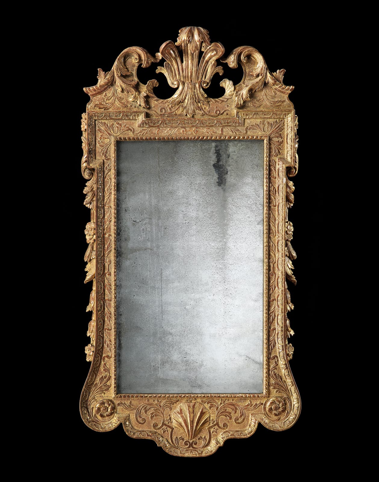 A GEORGE I CARVED AND GILDED MIRROR, ENGLISH, CIRCA 1725
