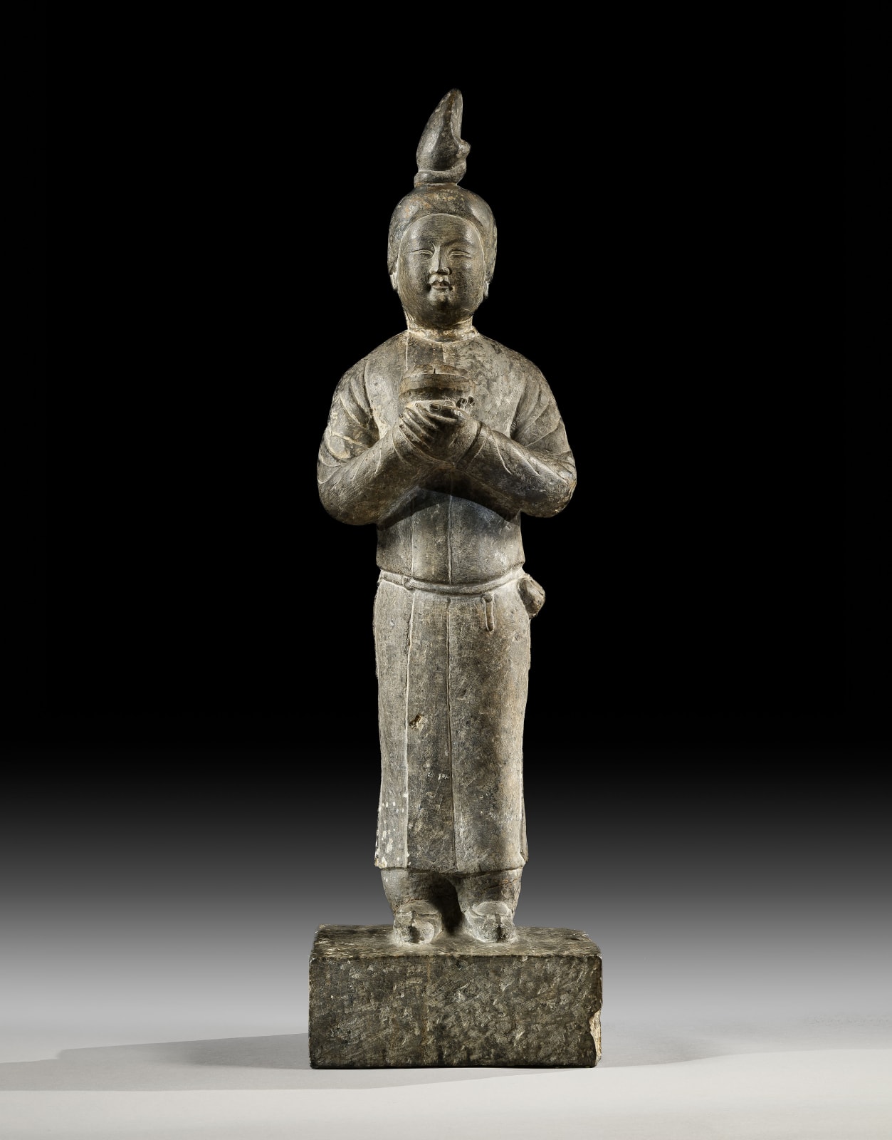 A LIMESTONE FIGURE OF A FEMALE ATTENDANT, CHINA, TANG DYNASTY (618 - 907), 7TH CENTURY