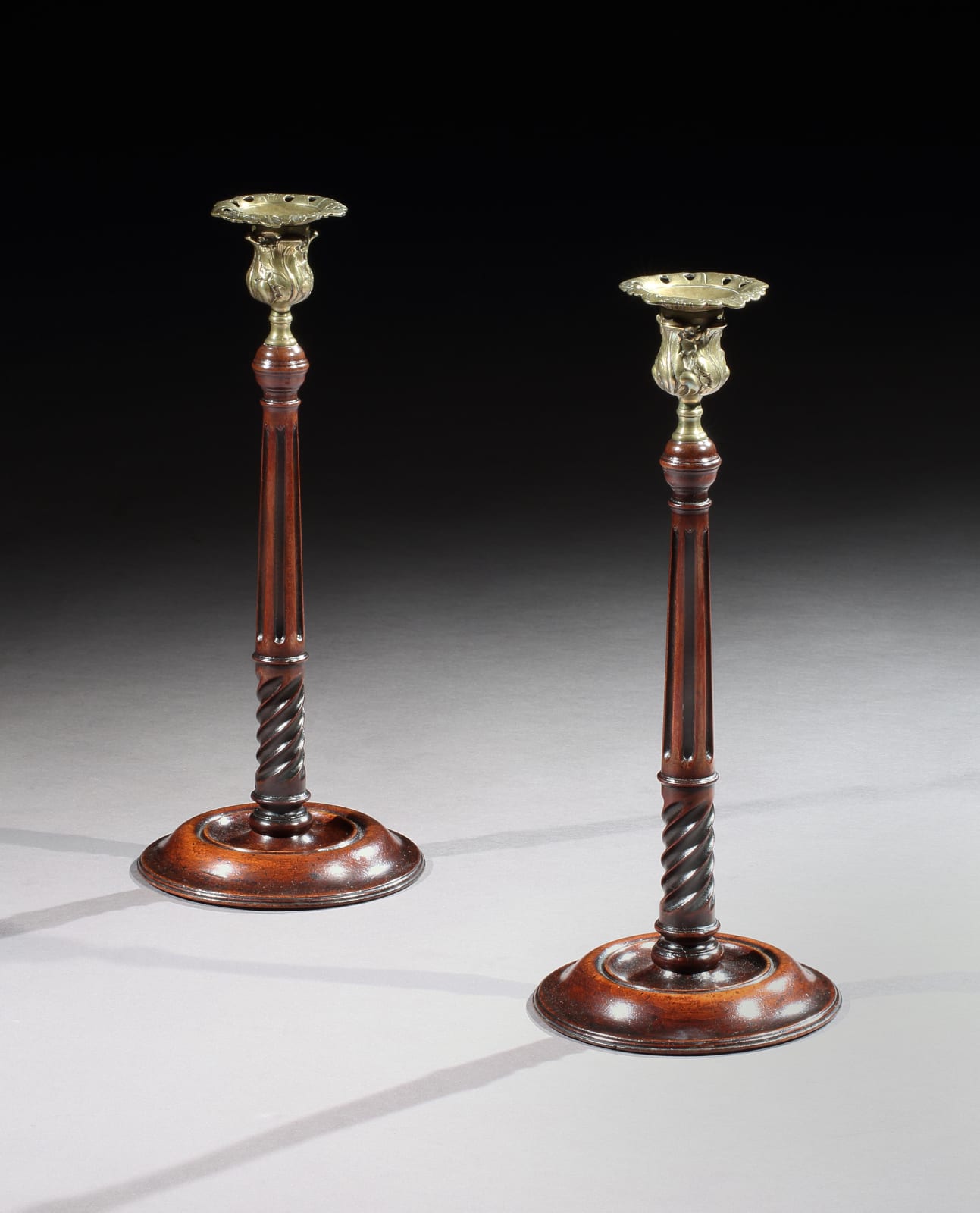A PAIR OF GEORGE III MAHOGANY CANDLESTICKS, ENGLISH, CIRCA 1765