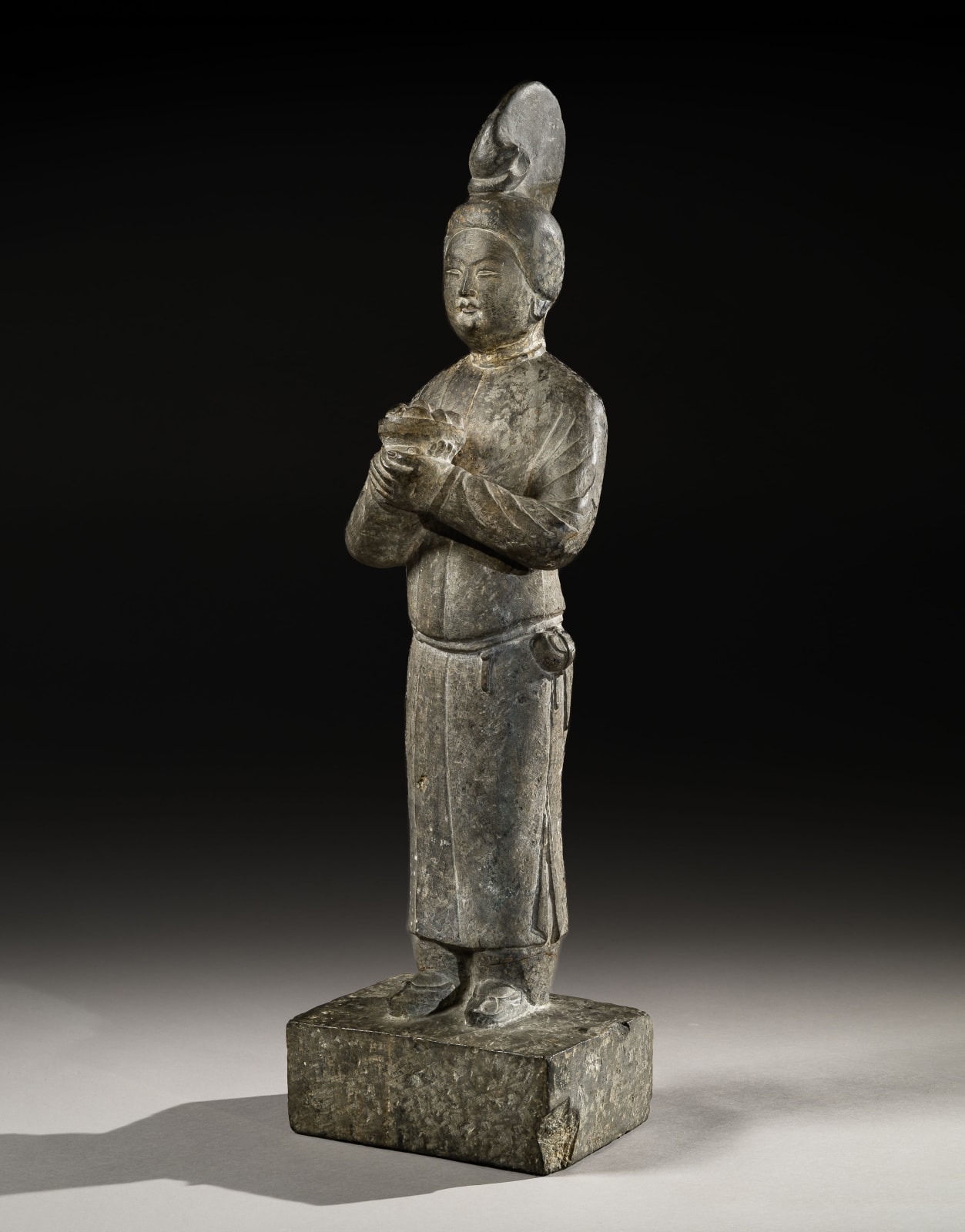 A LIMESTONE FIGURE OF A FEMALE ATTENDANT, CHINA, TANG DYNASTY (618 - 907), 7TH CENTURY