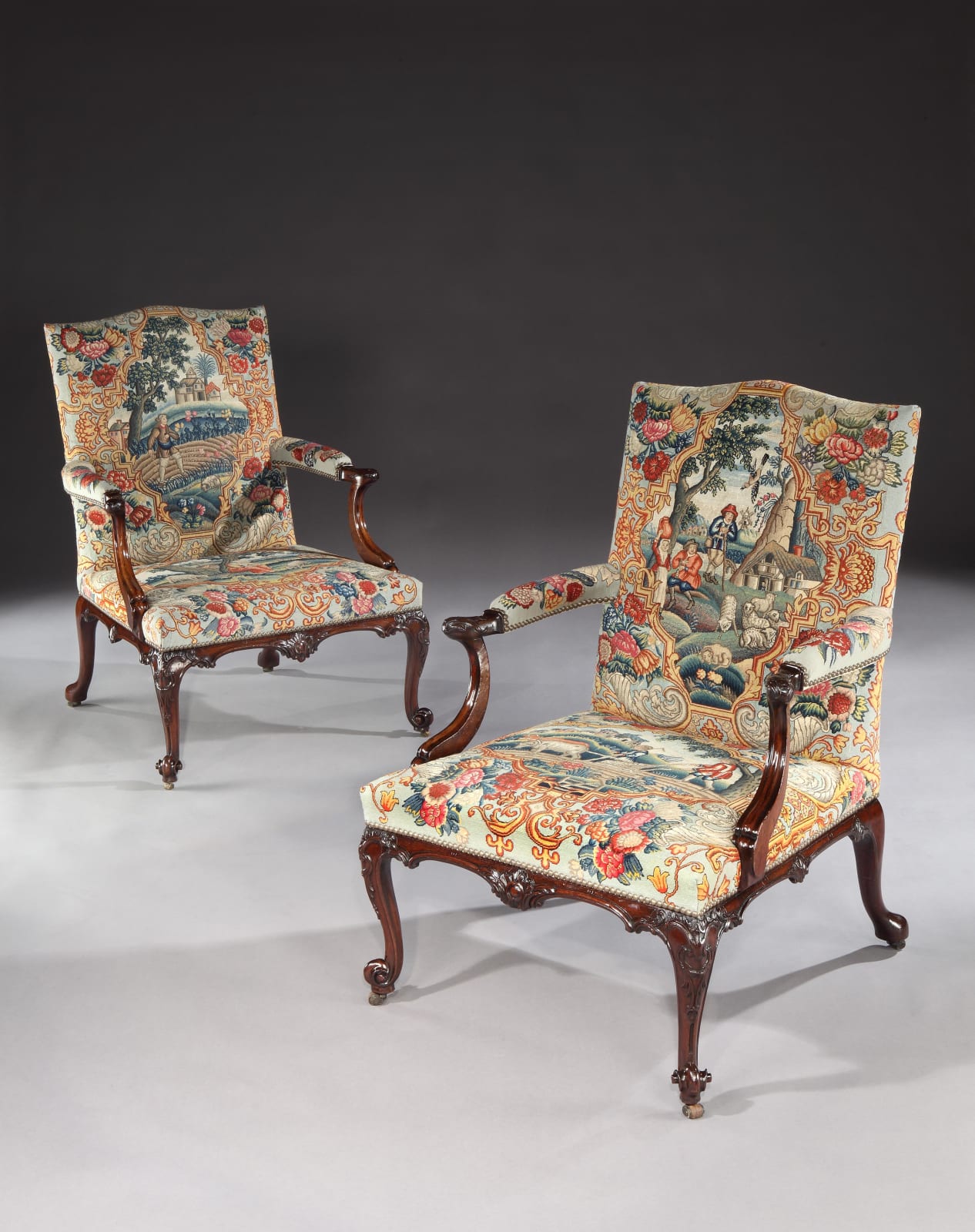 A PAIR OF GEORGE III MAHOGANY NEEDLEWORK LIBRARY ARMCHAIRS , Chairs: English, circa 1760  Needlework: English, circa 1740