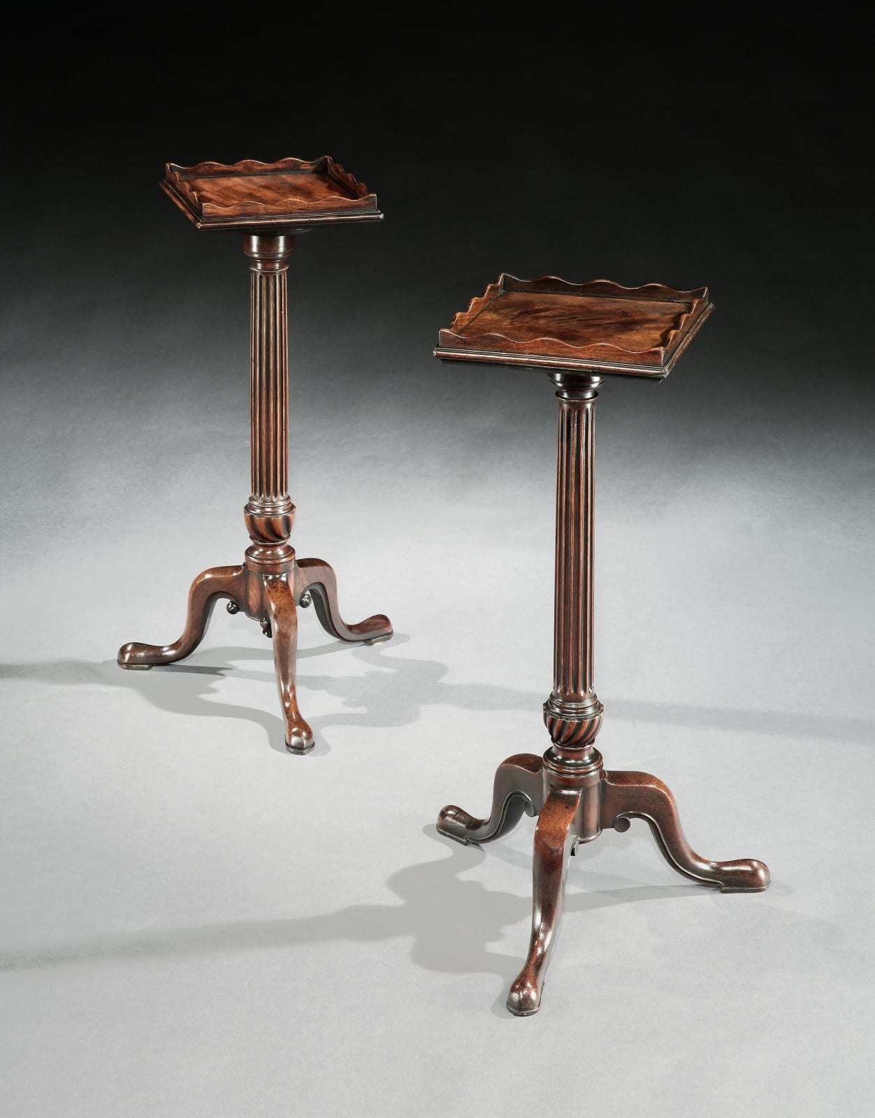 A NEAR PAIR OF GEORGE III MAHOGANY URN STANDS, English, circa 1770