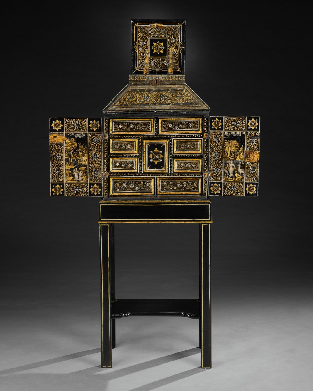 A JAMES I PERIOD JAPANNED CABINET ON STAND, The cabinet: European, circa 1620 The stand: American, 20th century