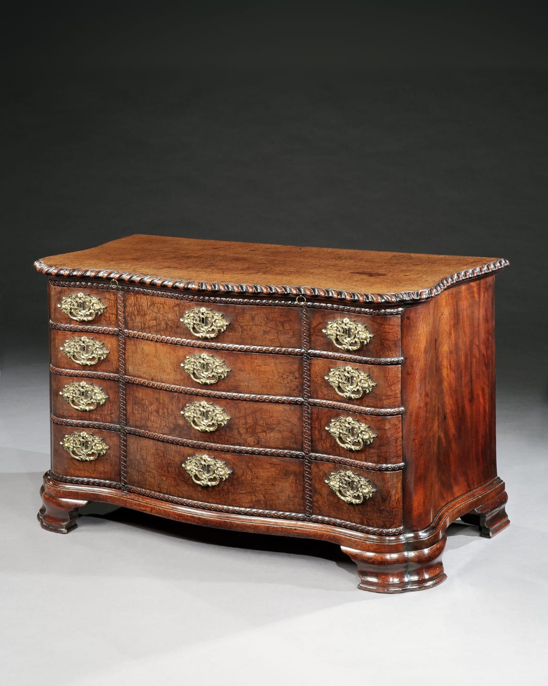 A GEORGE II QUILTED MAHOGANY COMMODE, English, circa 1750