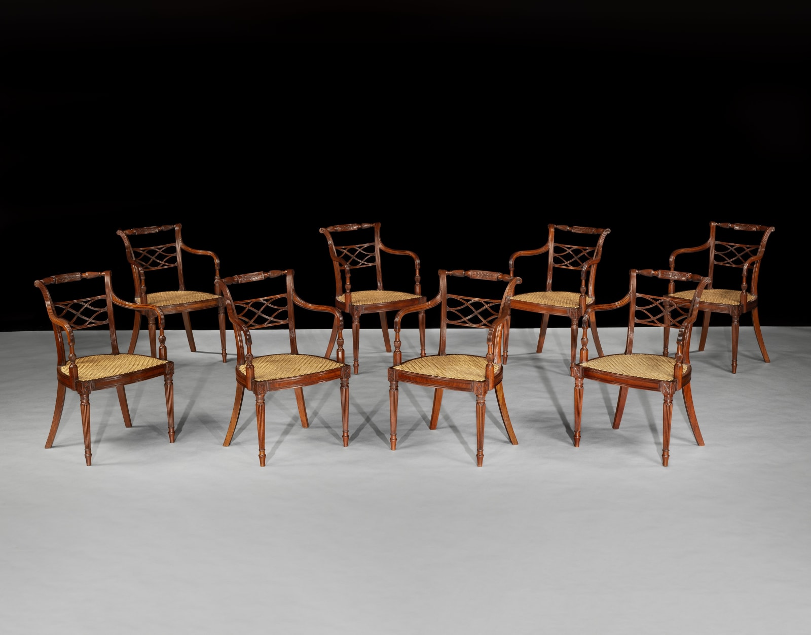 A SET OF EIGHT GEORGE III MAHOGANY ARMCHAIRS, English, circa 1790