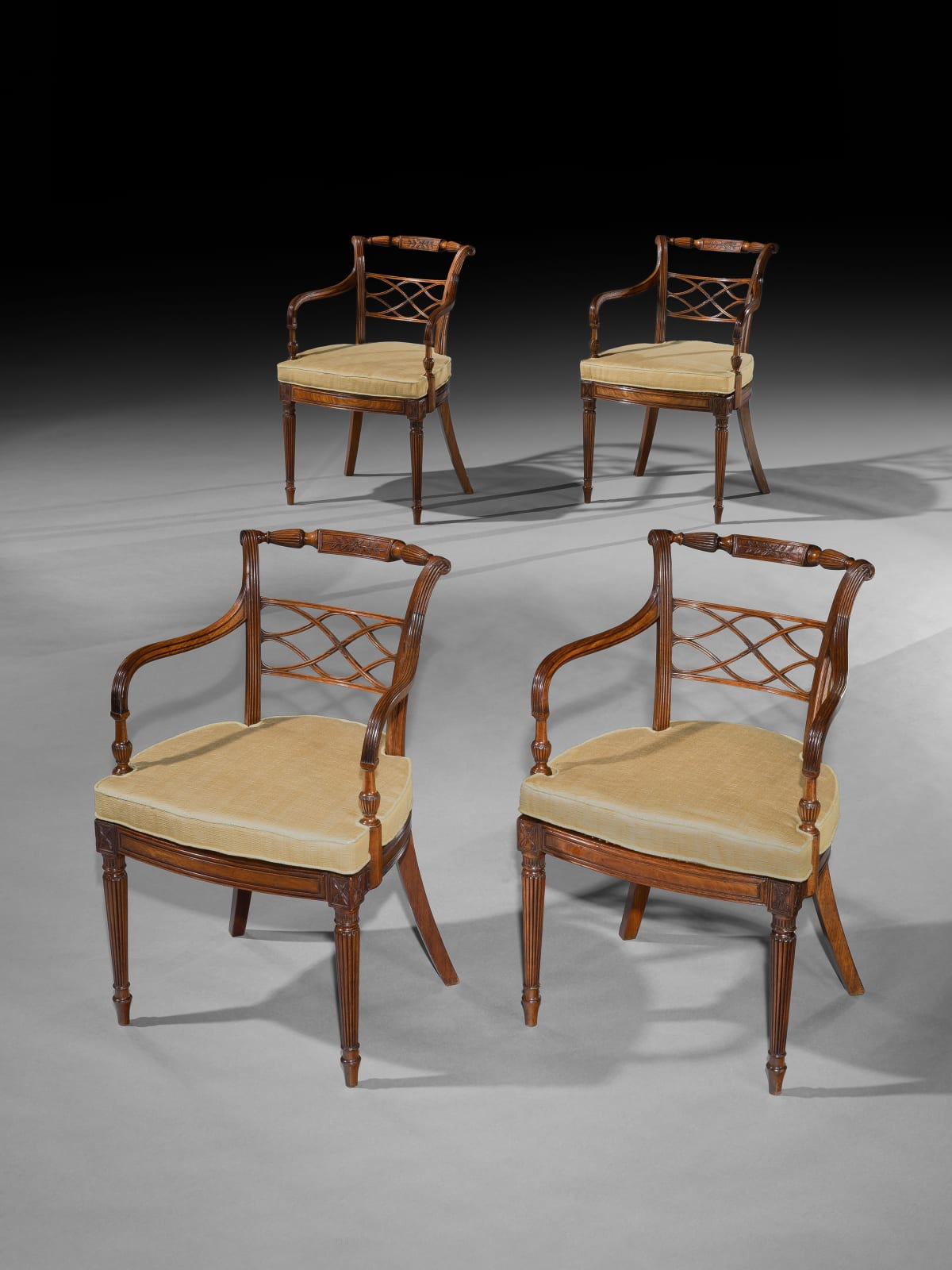 A SET OF EIGHT GEORGE III MAHOGANY ARMCHAIRS, English, circa 1790