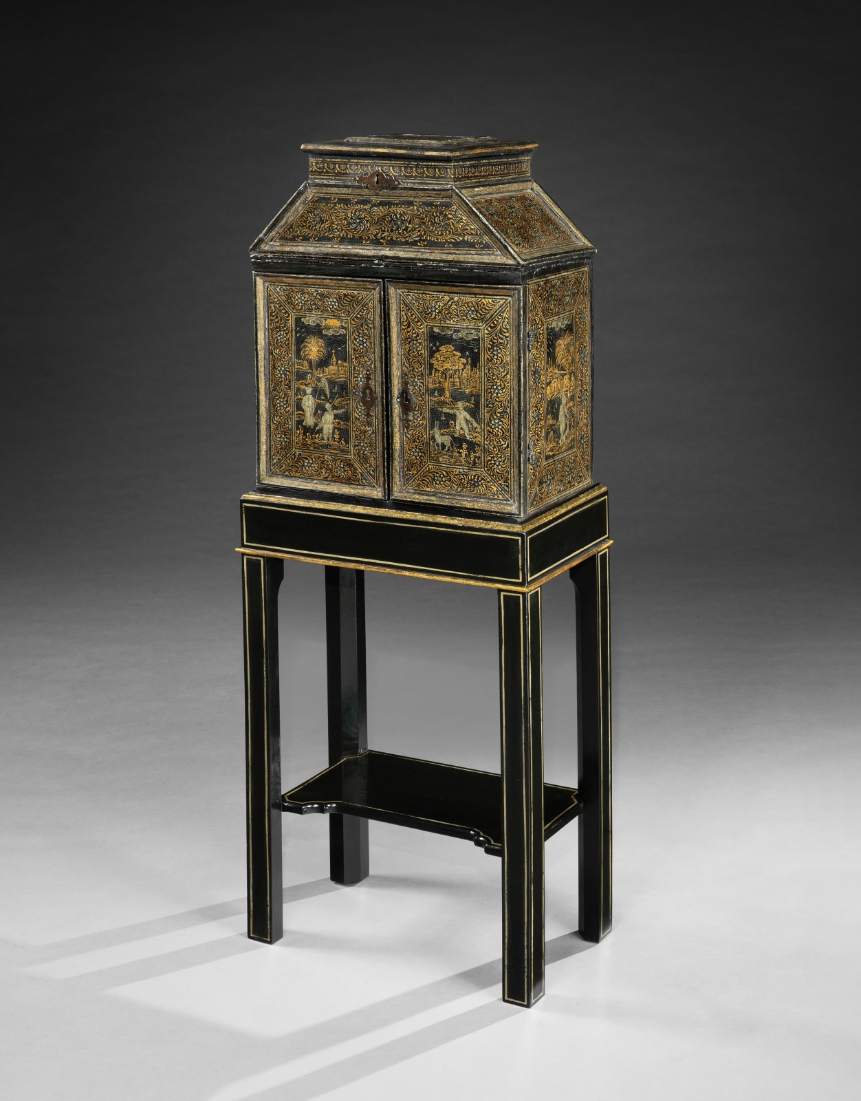 A JAMES I PERIOD JAPANNED CABINET ON STAND, The cabinet: European, circa 1620 The stand: American, 20th century
