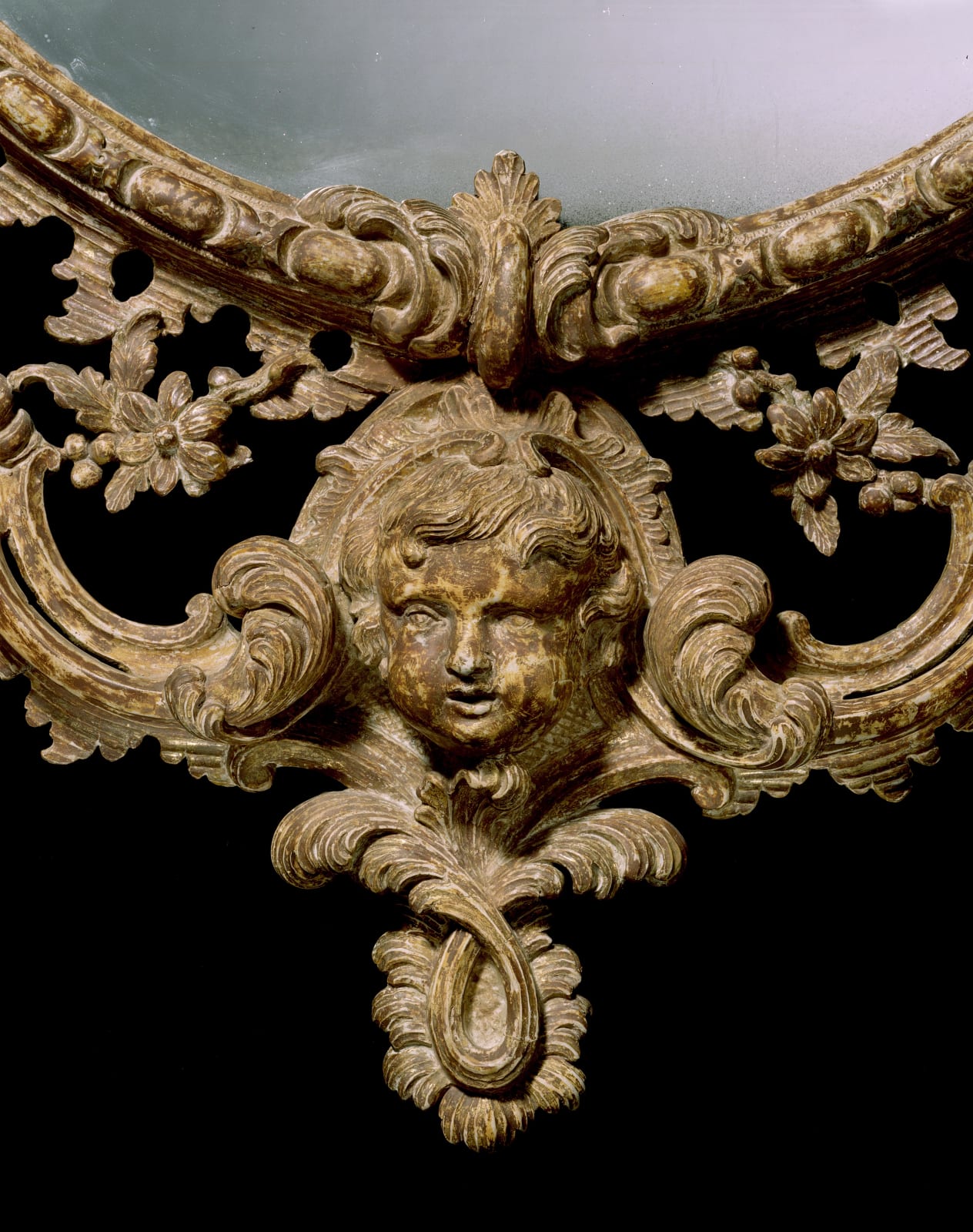 A GEORGE III GILTWOOD OVAL MIRROR, English, circa 1765