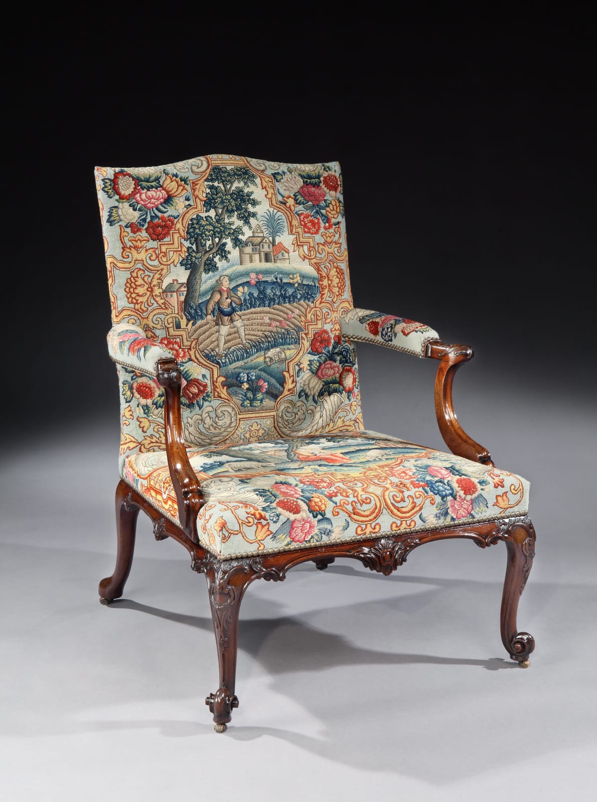 A PAIR OF GEORGE III MAHOGANY NEEDLEWORK LIBRARY ARMCHAIRS , Chairs: English, circa 1760  Needlework: English, circa 1740