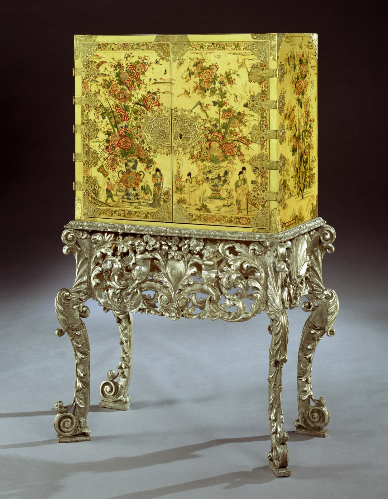 A CHARLES II CREAM JAPANNED CABINET ON SILVERED STAND , English, circa 1680