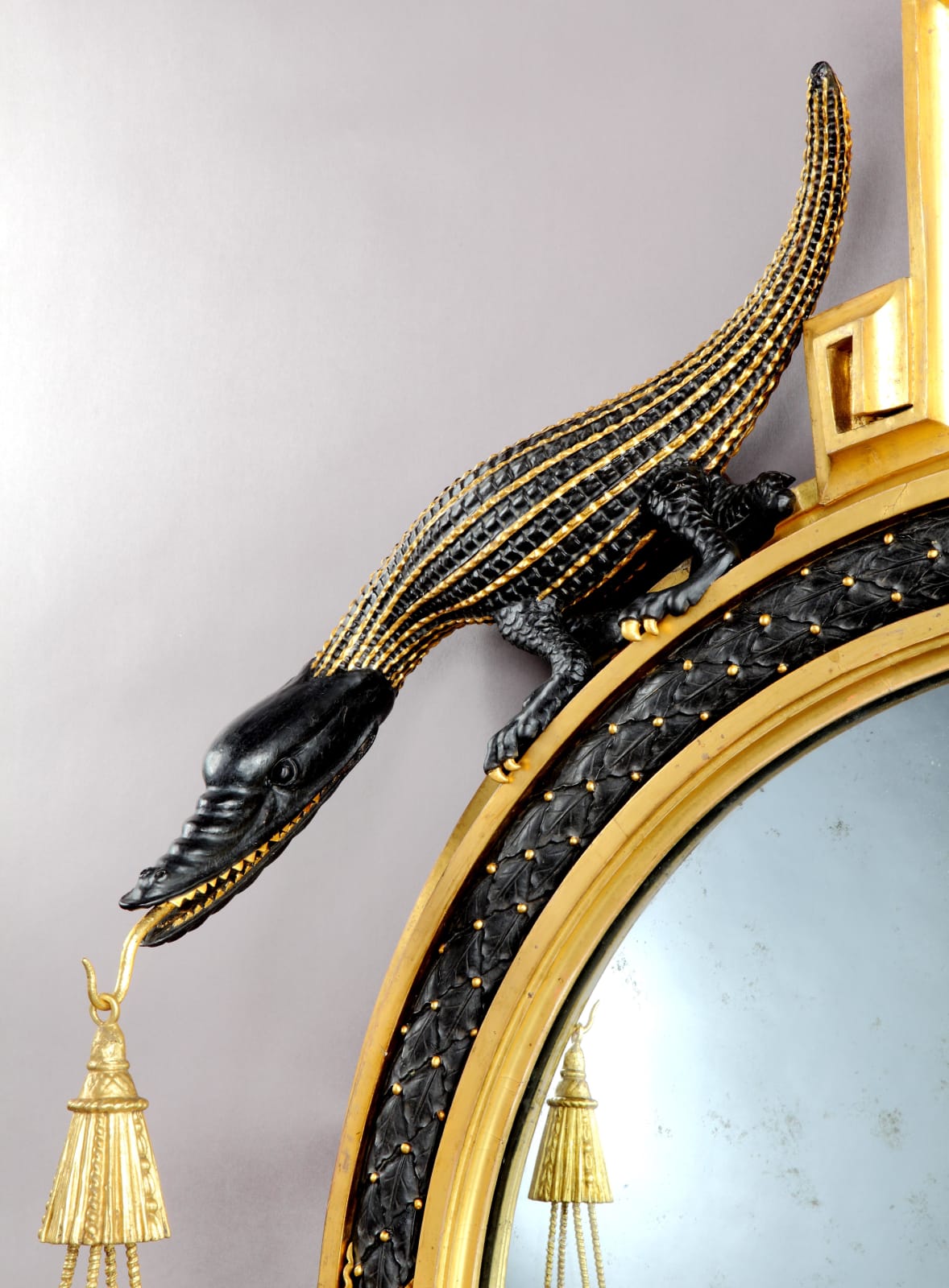 A GEORGE III GILTWOOD AND BRONZE PAINTED CONVEX MIRROR, English, between 1798-1805