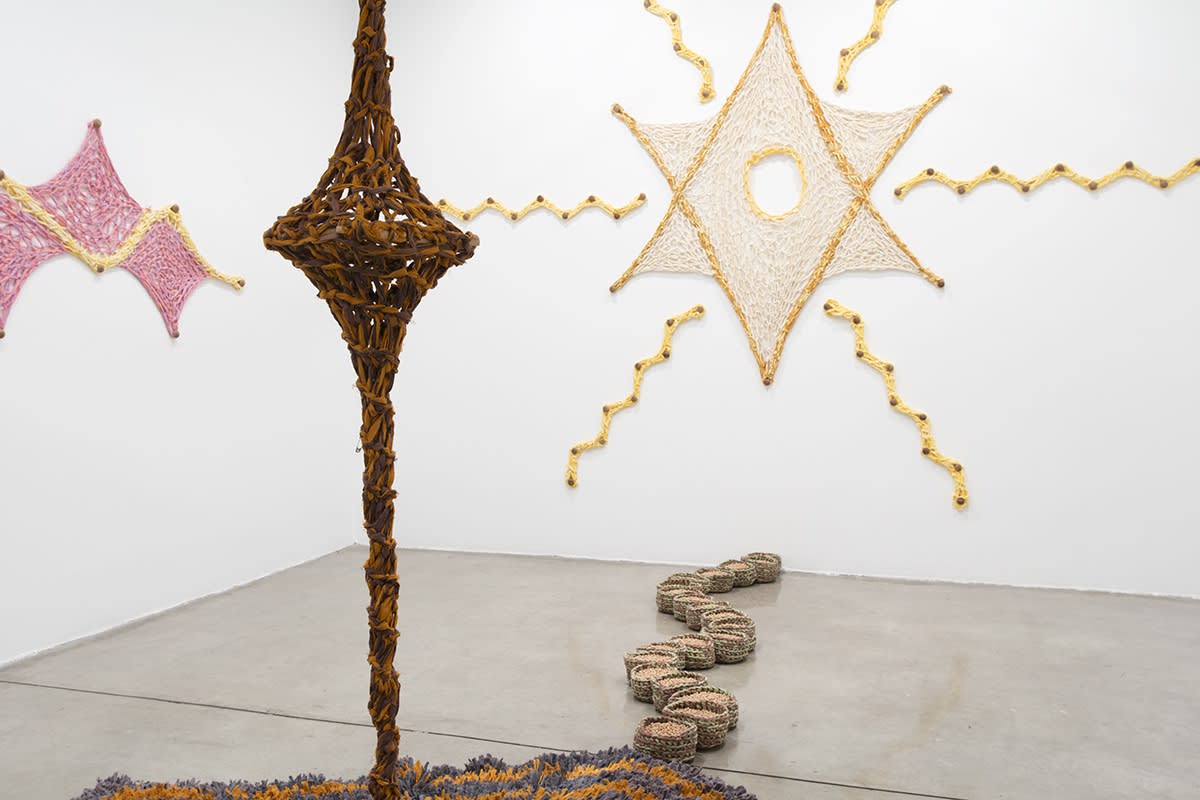 Ernesto Neto installation with crochet in middle of room and crochet on the wall